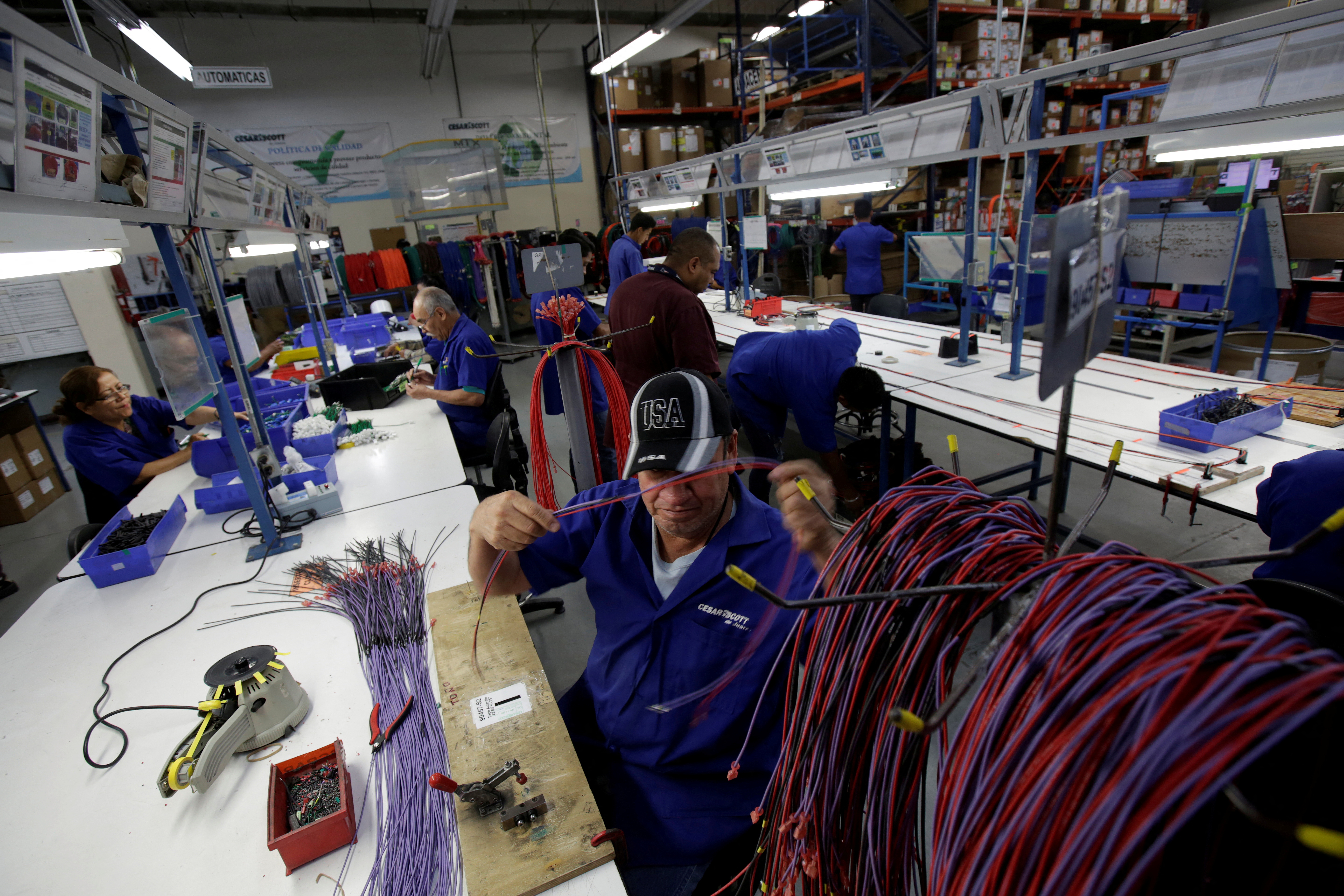 Employees work at a wire harness and cable assembly manufacturing company that exports to the U.S., in Ciudad Juarez