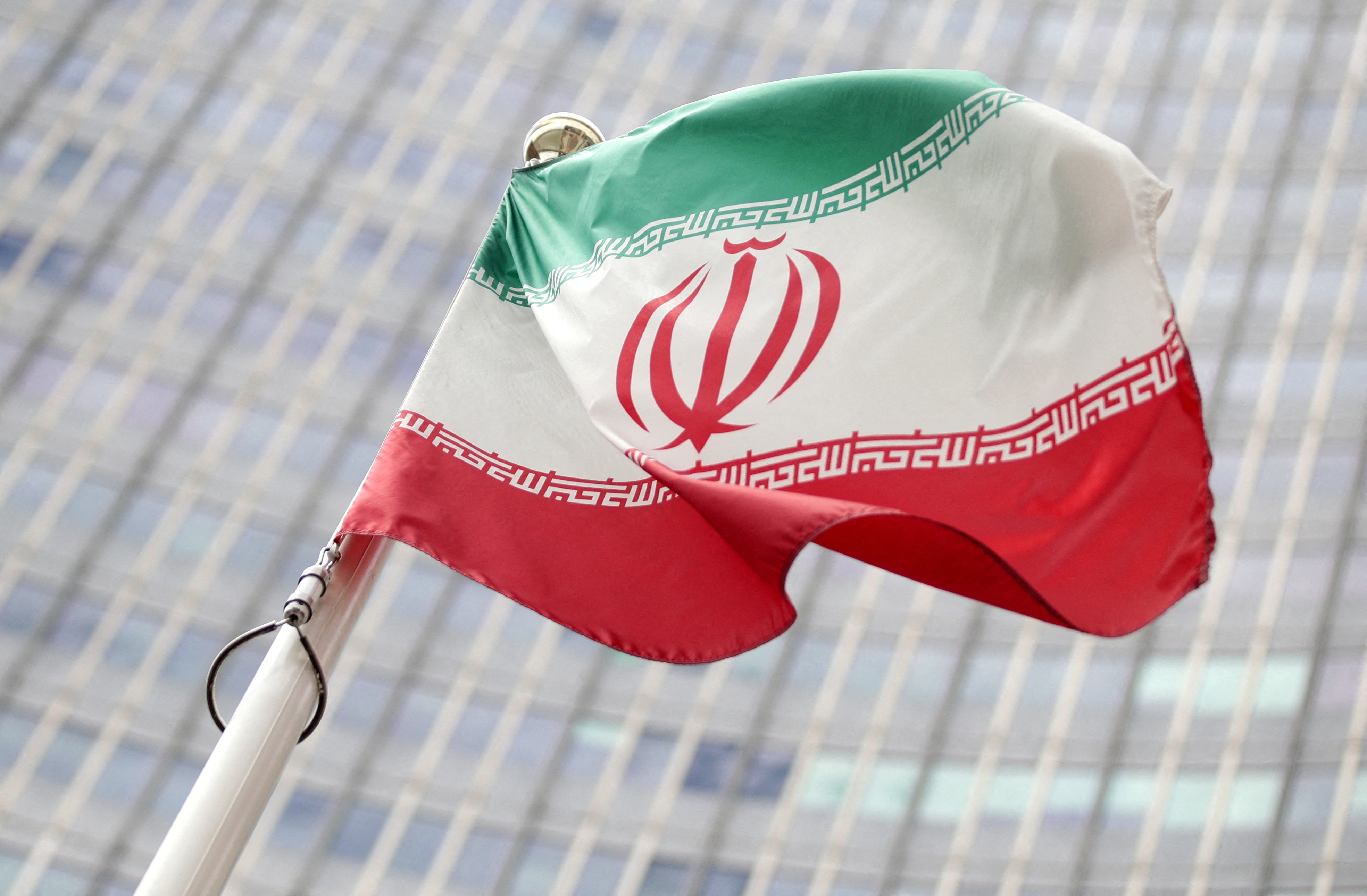 The Iranian flag flutters in front of the International Atomic Energy Agency headquarters in Vienna