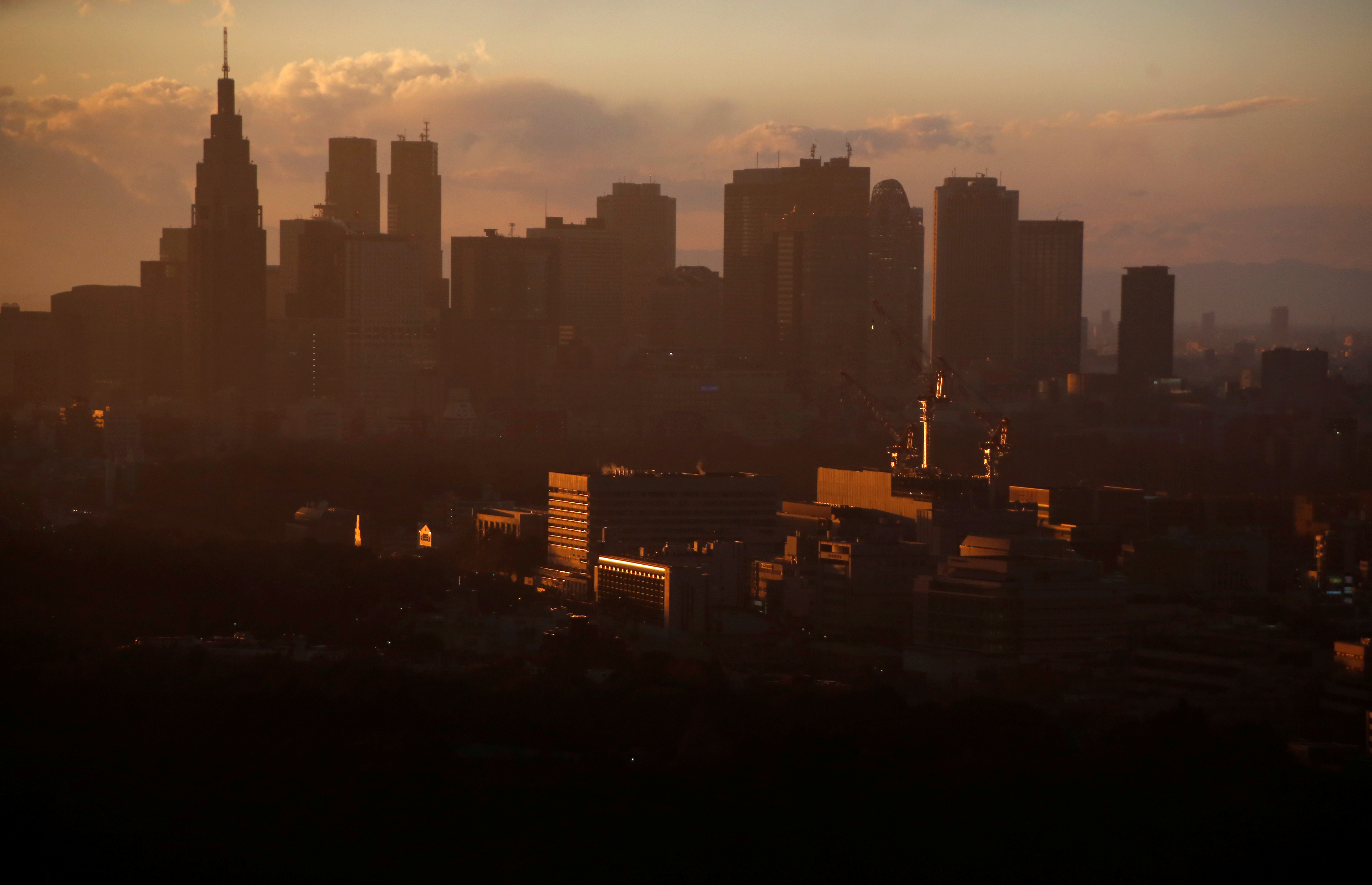 High-rise buildings are seen at the Shinjuku business district during sunset in Tokyo