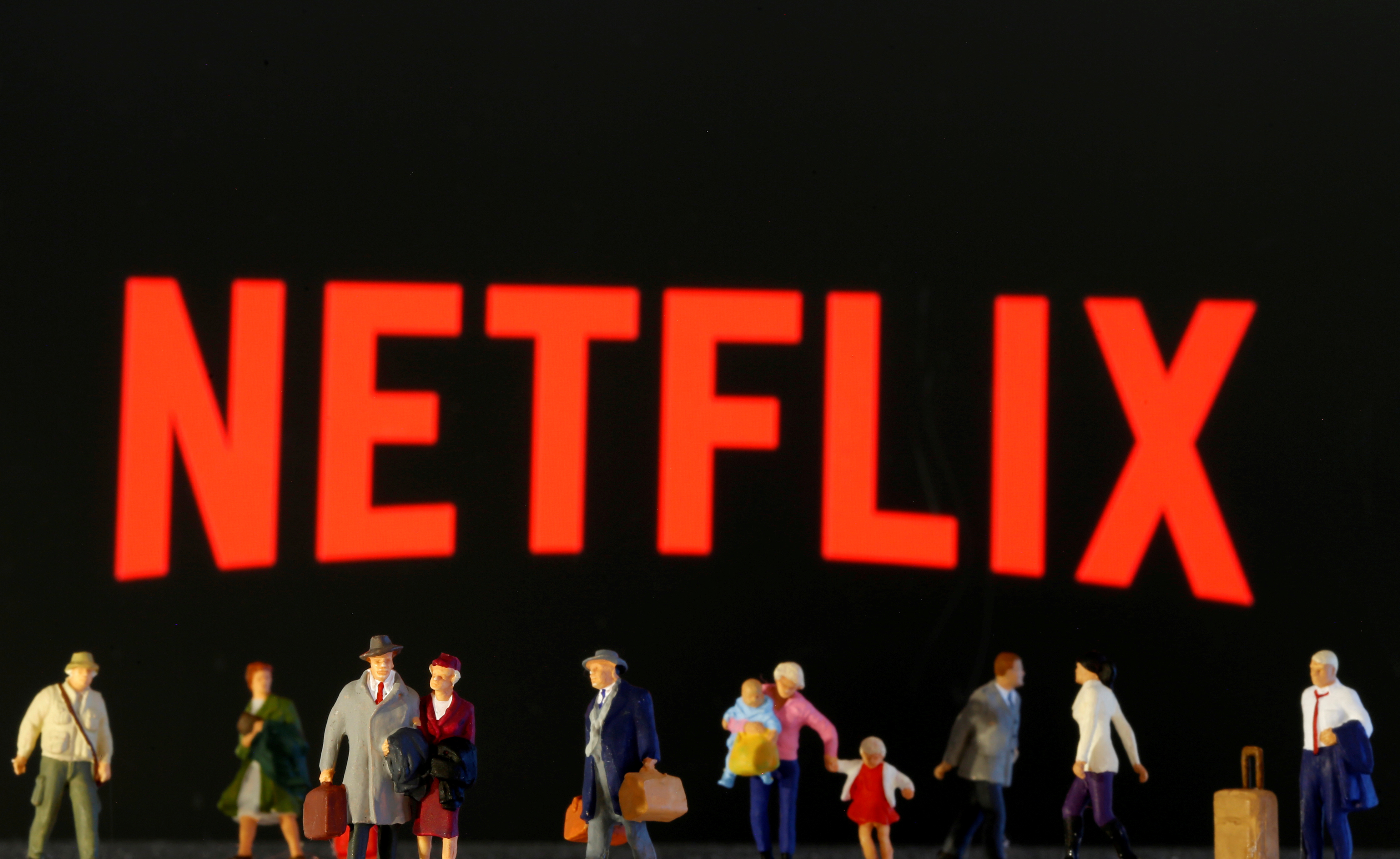 Small toy figures are seen in front of diplayed Netflix logo in this illustration taken March 19, 2020. REUTERS/Dado Ruvic/Illustration/File Photo