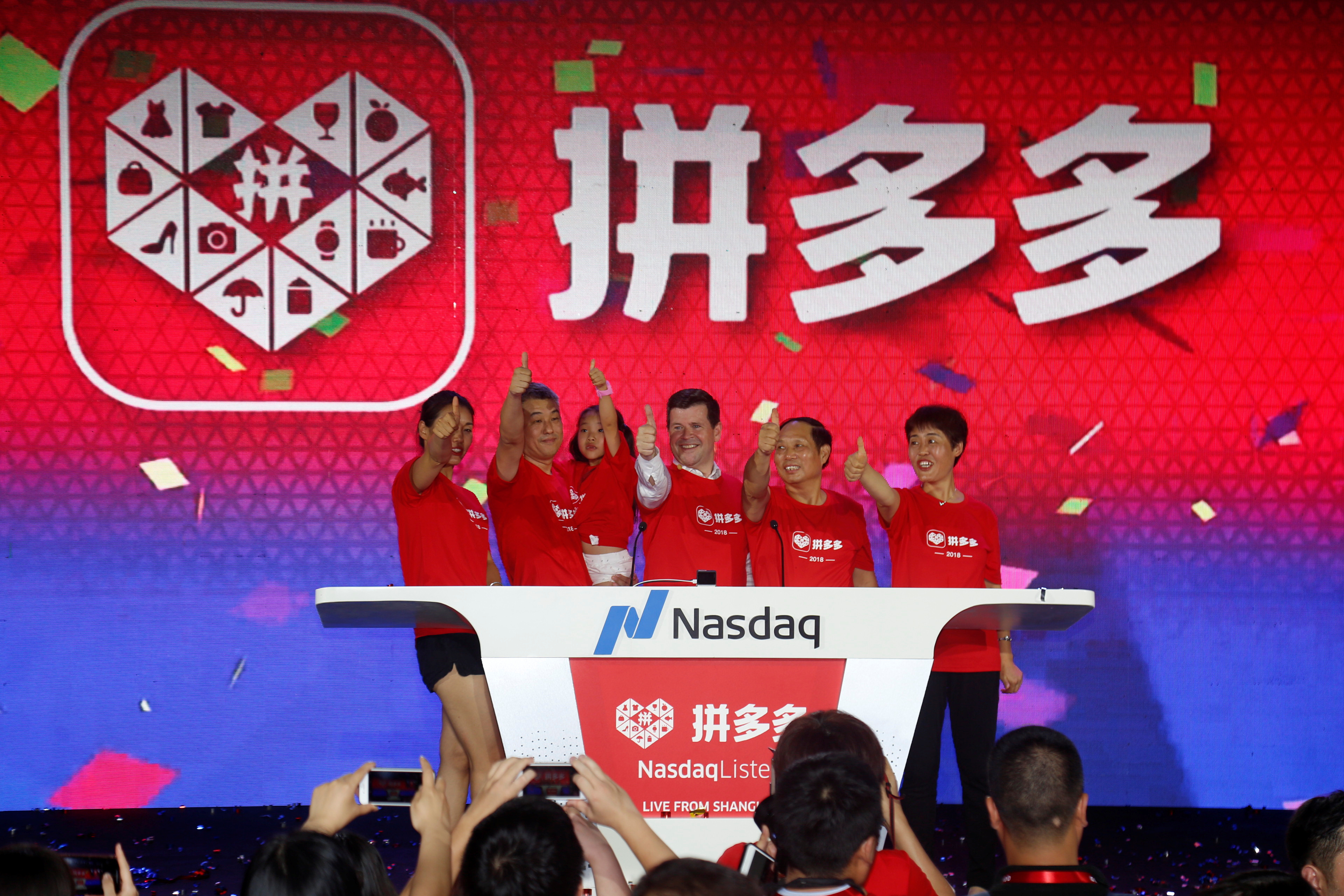 Users of the online group discounter Pinduoduo ring the opening bell on the Nasdaq Stock Market in New York, during an event to mark its trading debut on market in Shanghai