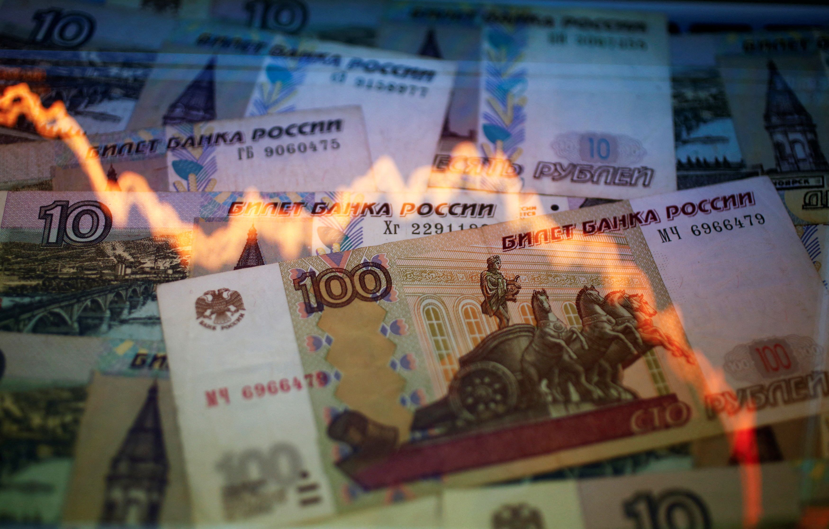 A reflection of a yearly chart of U.S. dollars and Russian roubles are seen on rouble notes in this illustration picture taken in Warsaw