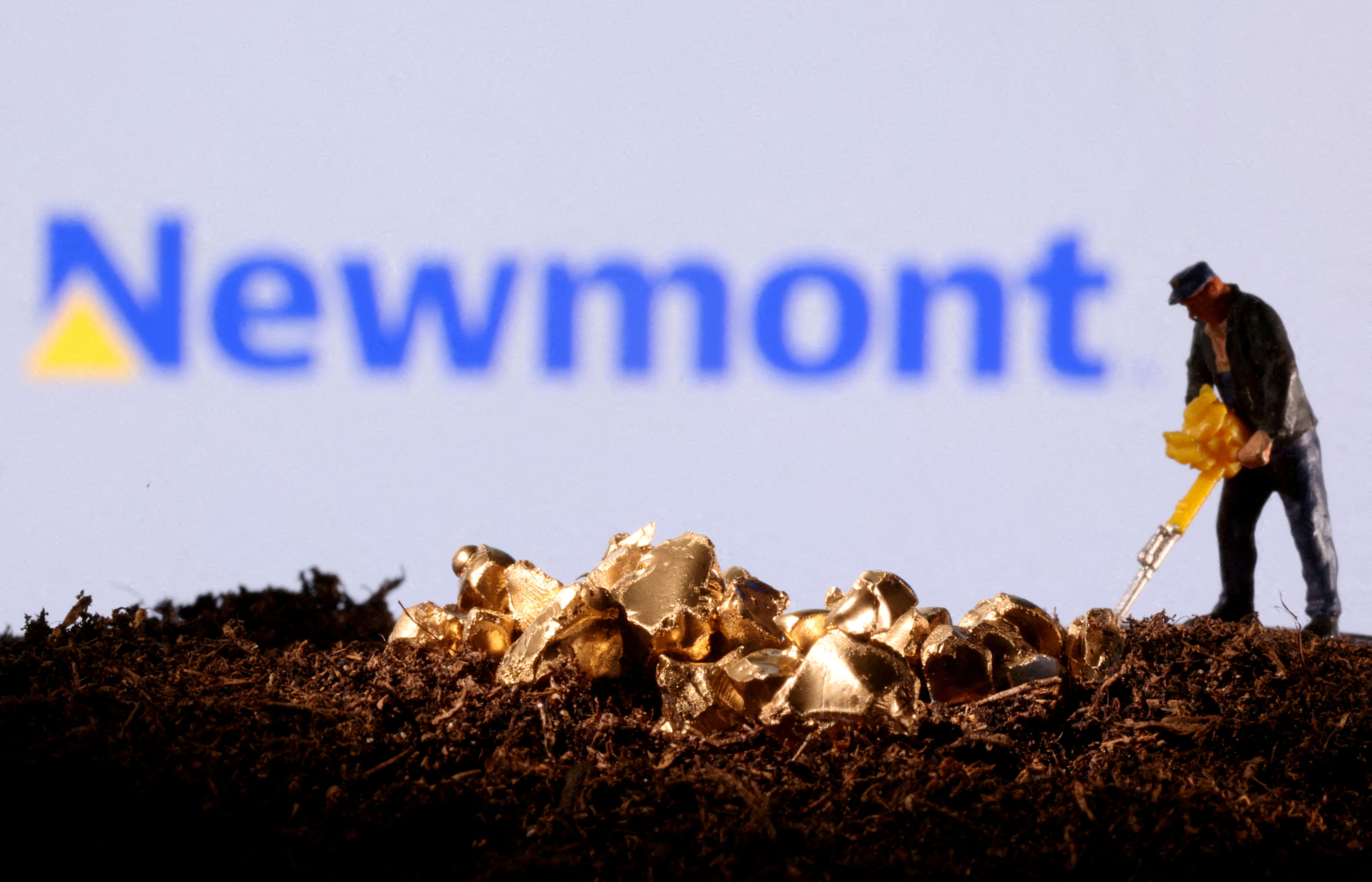 Small toy figure and gold imitation are seen in front of the Newmont logo in this illustration