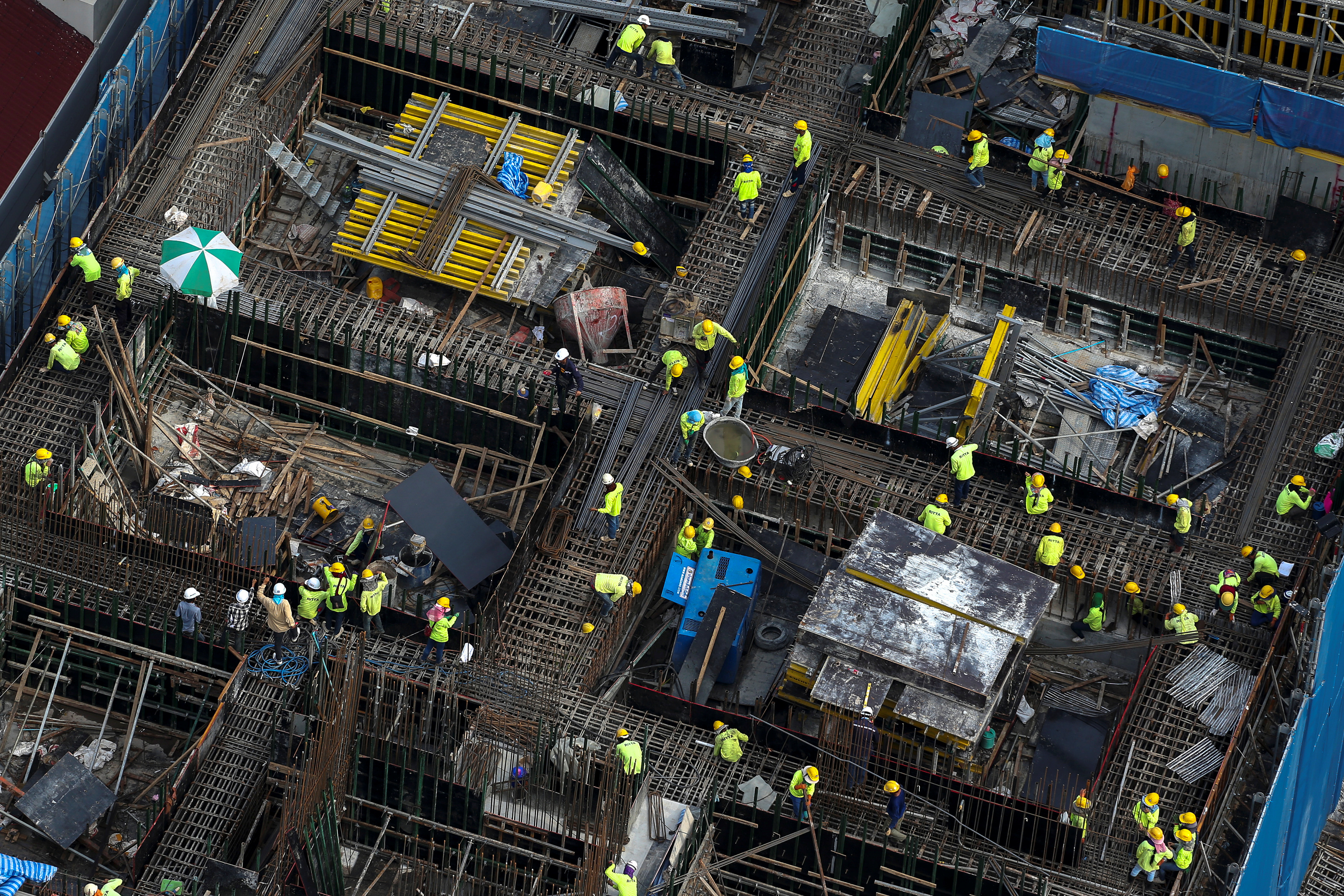 Workers work at a construction site in central Bangkok