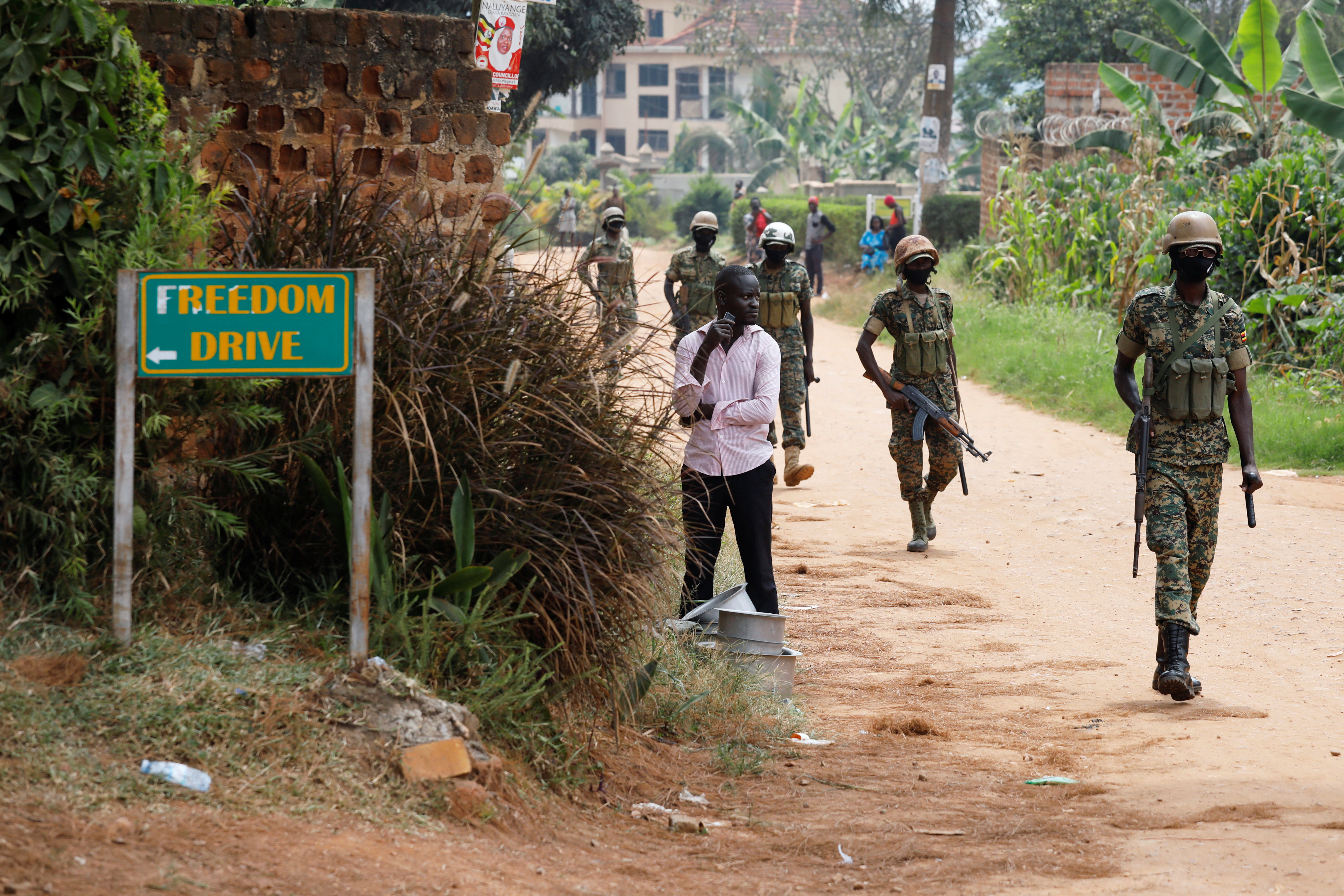 Ugandan soldiers patrol near the house of Ugandan opposition presidential candidate Robert Kyagulanyi in Kampala