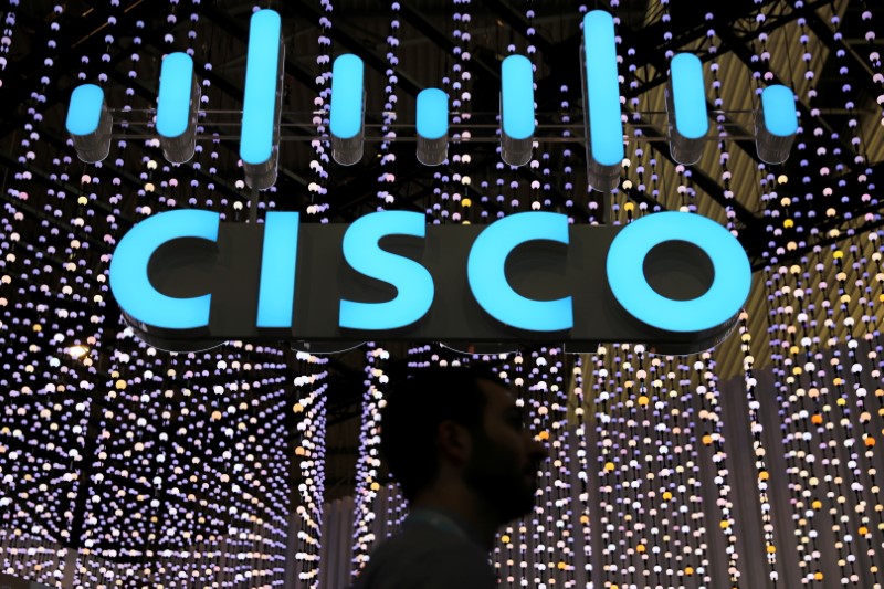 A man passes under a Cisco sign at the Mobile World Congress in Barcelona, Spain, February 25, 2019. REUTERS/Sergio Perez/File Photo