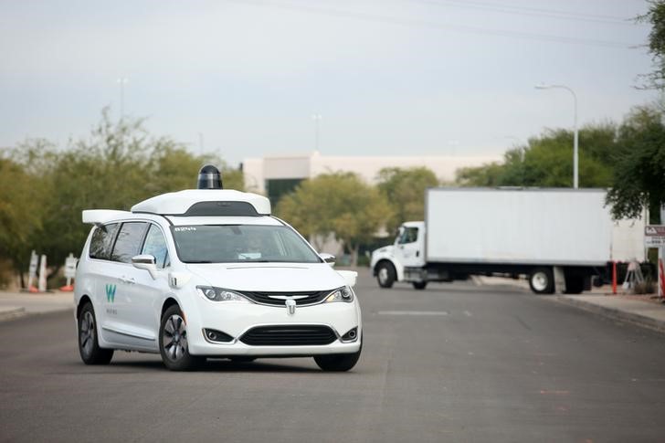 A Waymo Chrysler Pacifica Hybrid self-driving vehicle returns to a depot in Chandler, Arizona