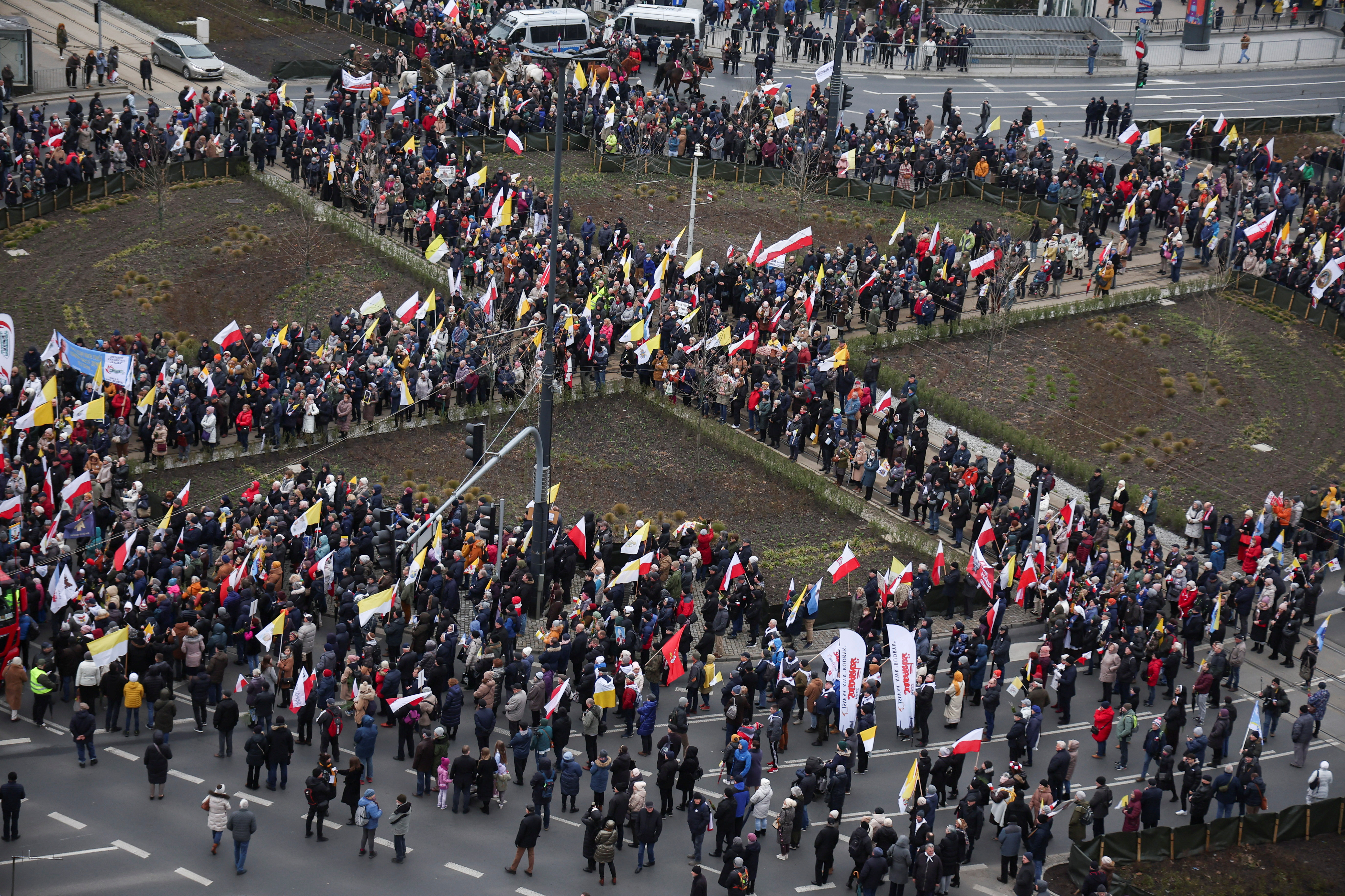 People march in defense of pope John Paul II on his death anniversary in Warsaw