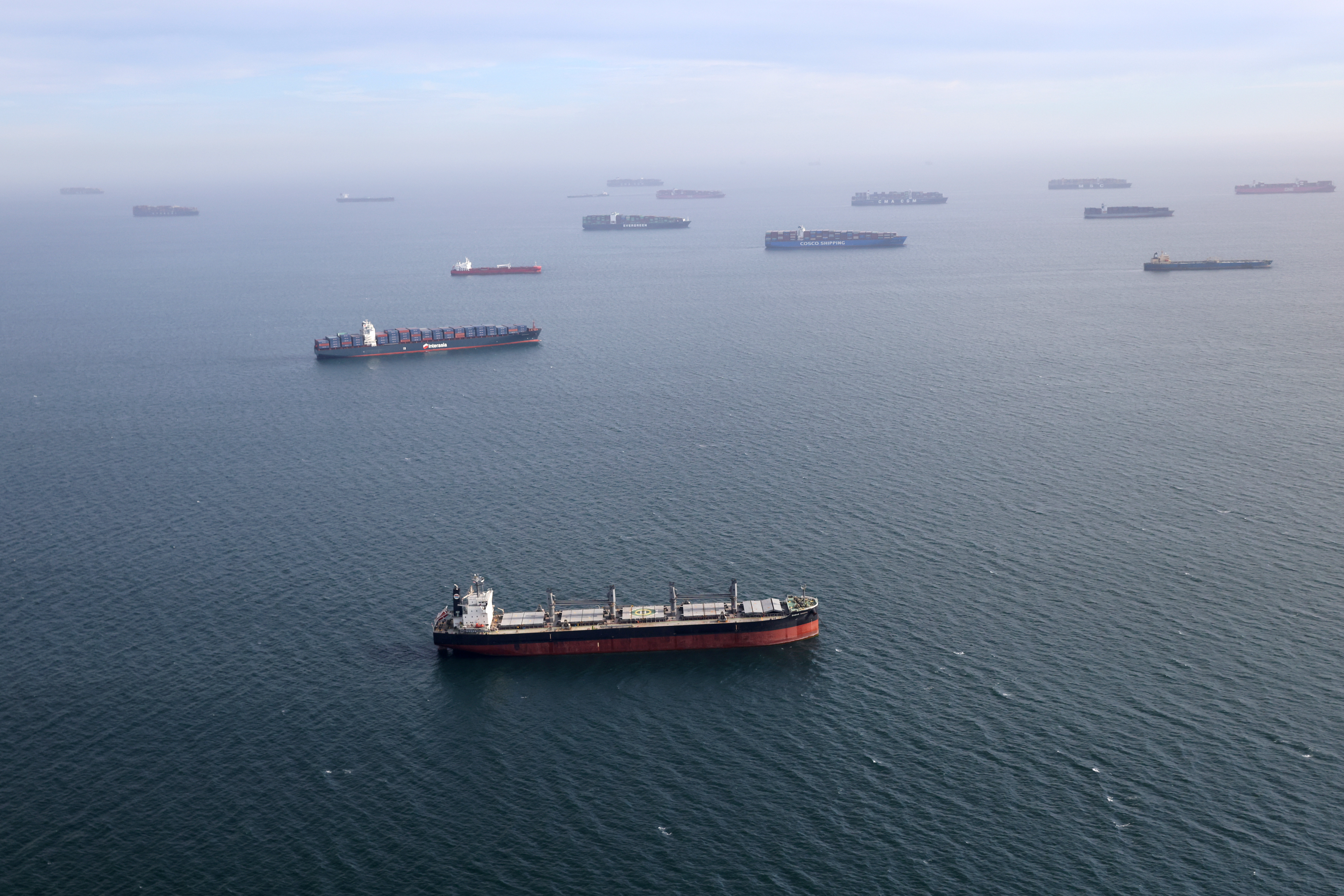 Container ships and oil tankers wait in the ocean outside the Port of Long Beach-Port of Los Angeles complex, amid the coronavirus disease (COVID-19) pandemic, in Los Angeles