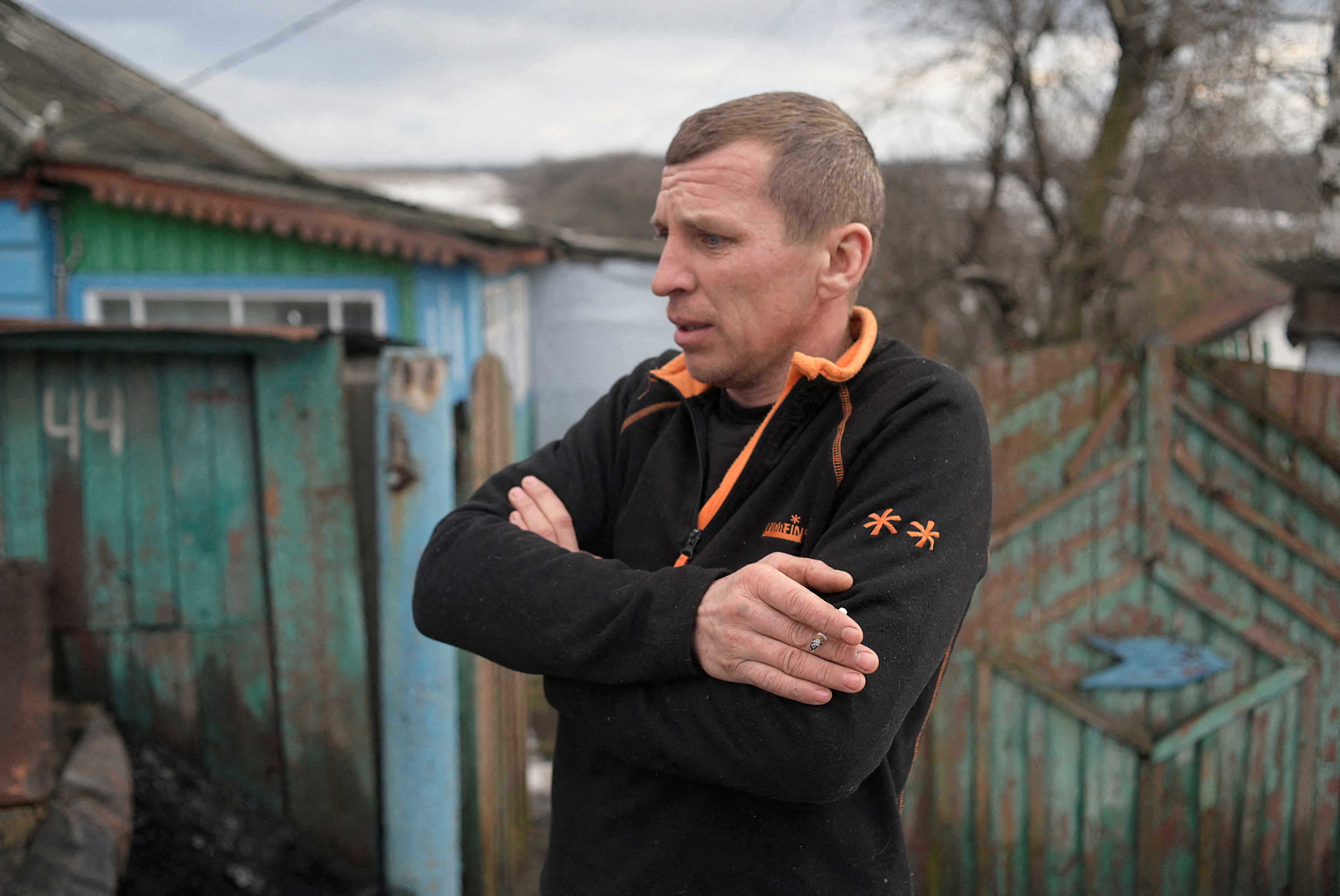 Local resident Serhiy smokes near his house in the village of Katerynivka in Luhansk Region