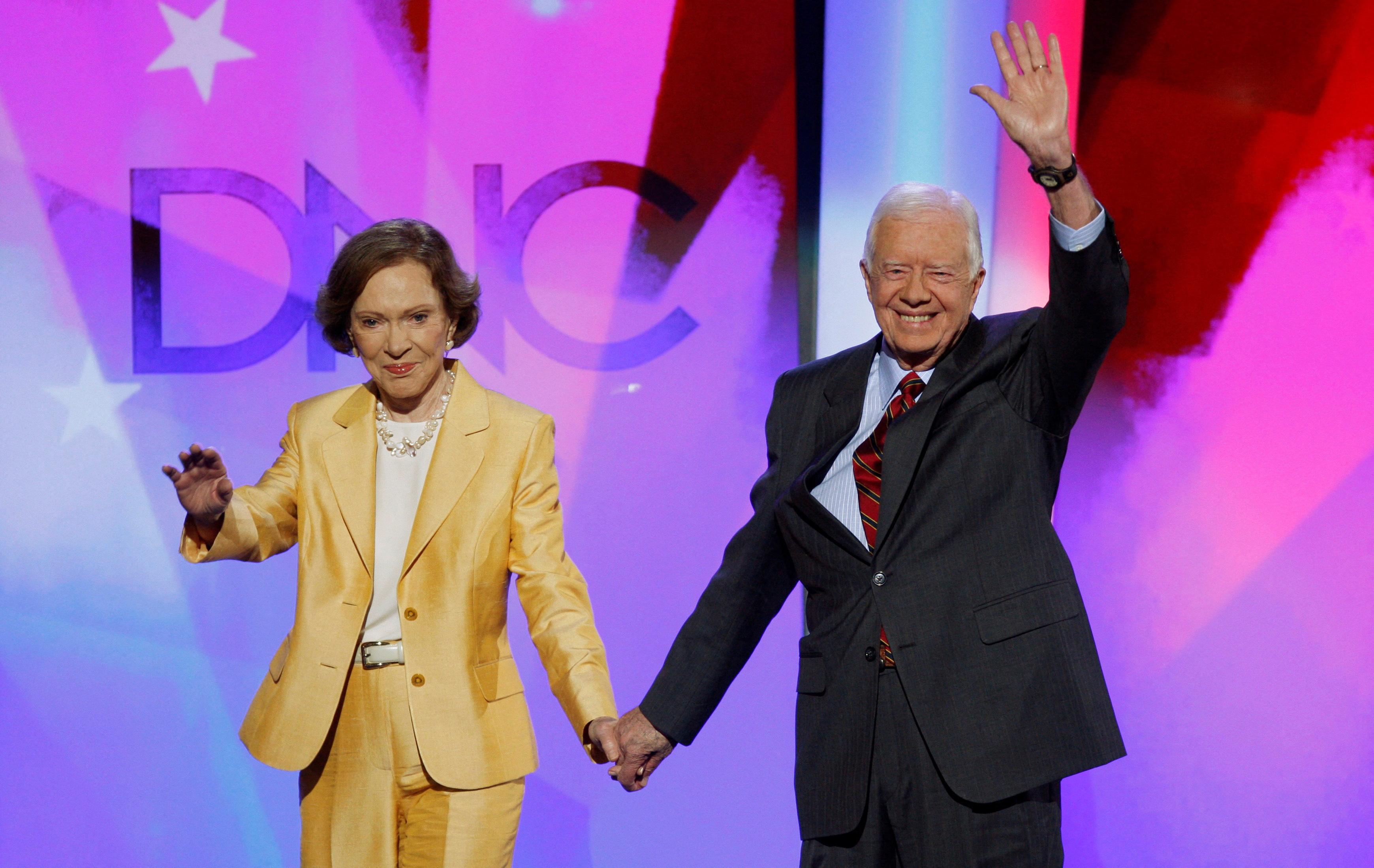 Former U.S. President Carter and former first lady Rosalynn arrive onstage in Denver