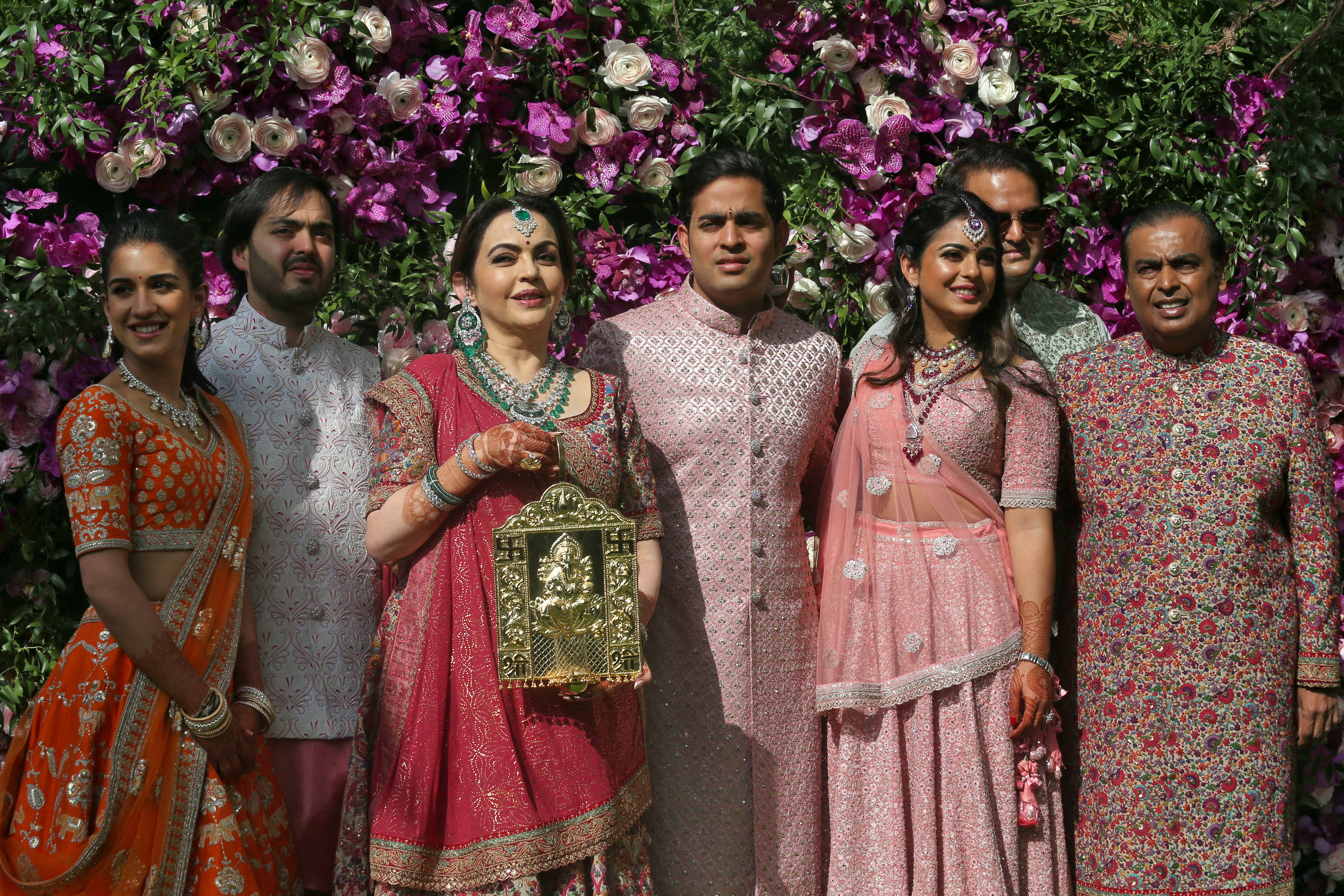 Radhika Merchant, Anant Ambani, Nita Ambani, Akash Ambani, Isha Piramal, Anand Piramal and Mukesh Ambani, the Chairman of Reliance Industries, pose at the wedding ceremony of Akash, at Bandra-Kurla Complex in Mumbai