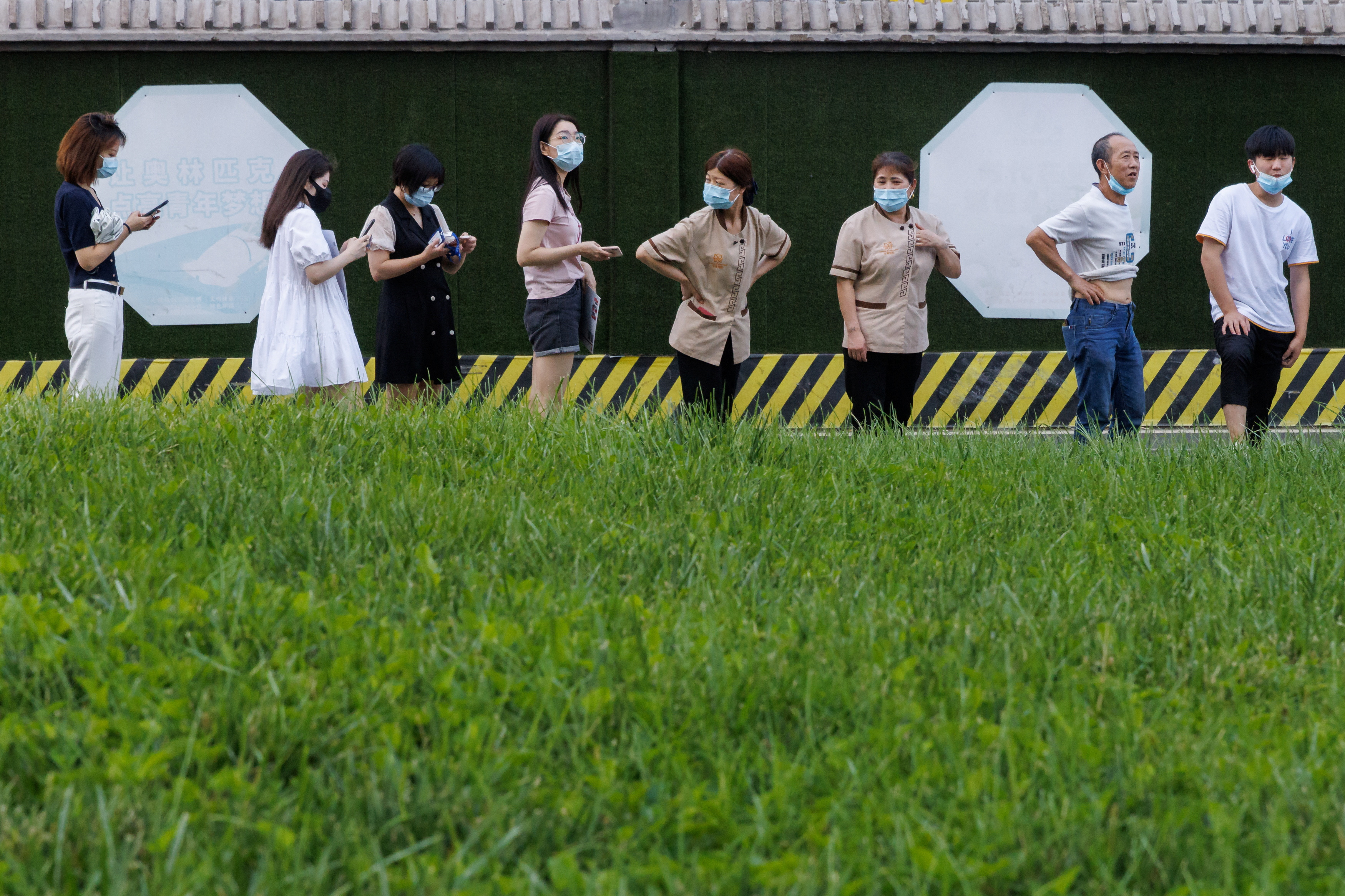 People line up at a nucleic acid testing station, following a coronavirus disease (COVID-19) outbreak, in Beijing