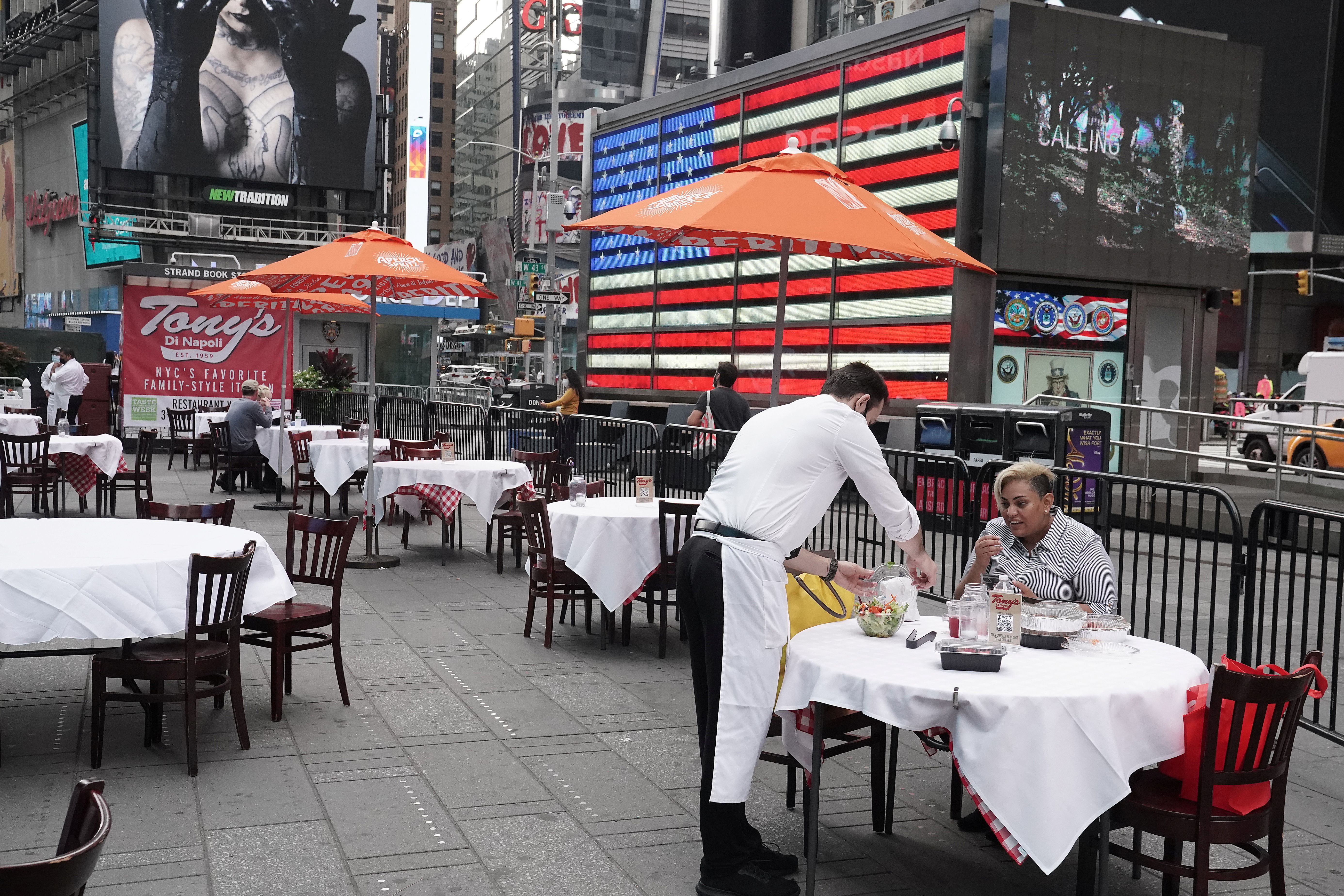 Servers package food at a table at a pop up restaurant set up in Times Square in New York