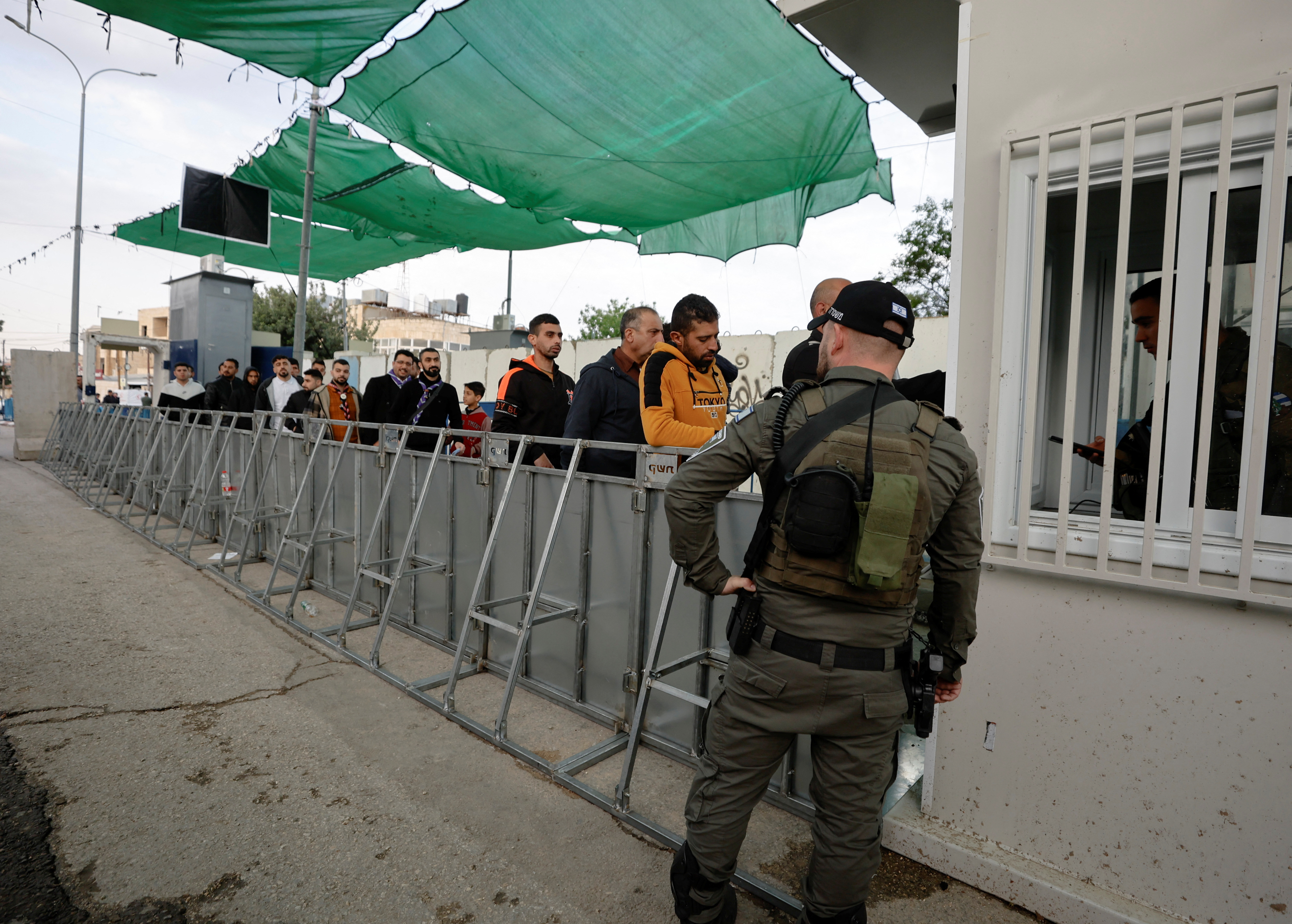 Palestinians make their way to attend the first Friday prayers of Ramadan through an Israeli checkpoint, in Bethlehem