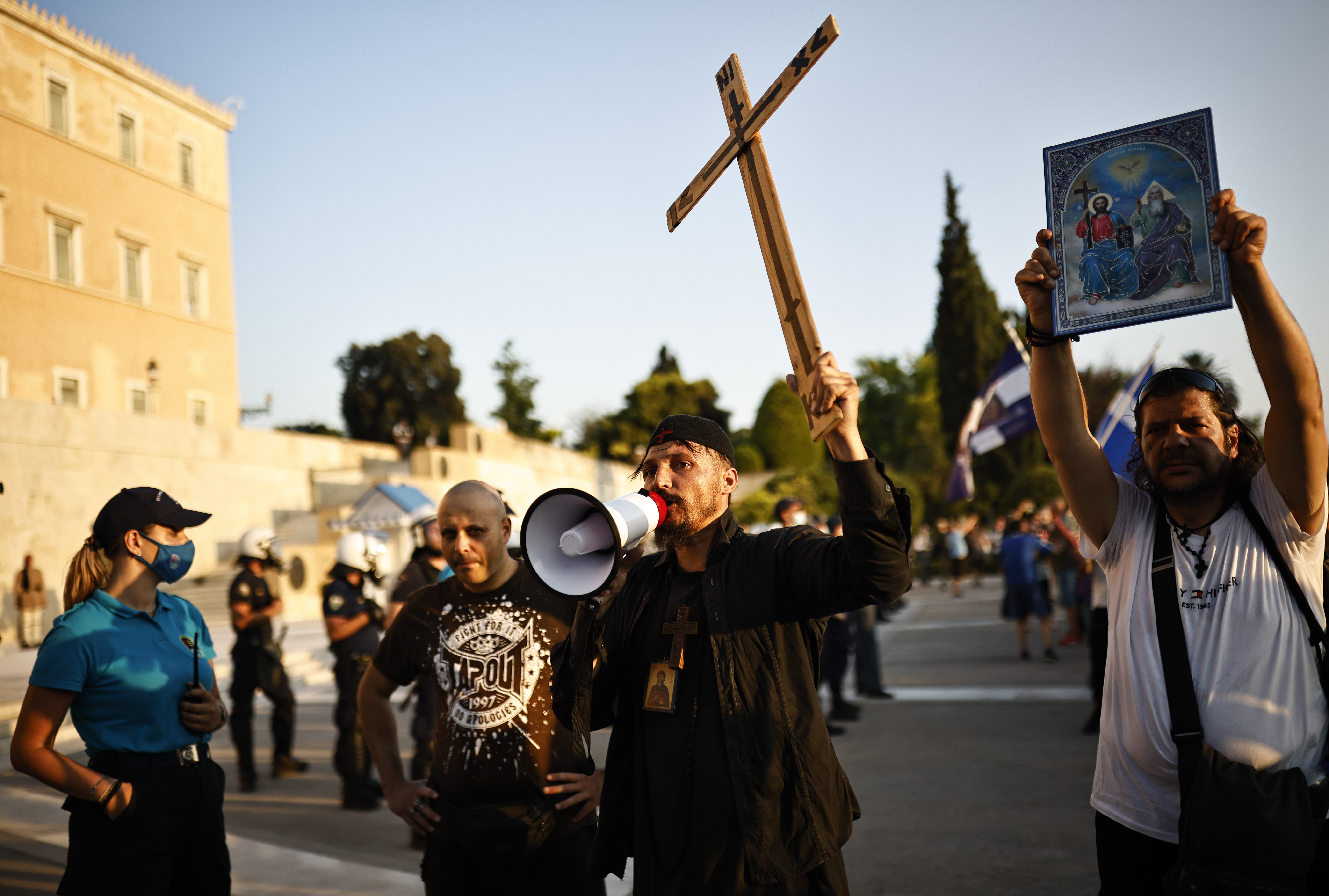 Anti-vaccine protesters take part in a demonstration outside the parliament building in Athens