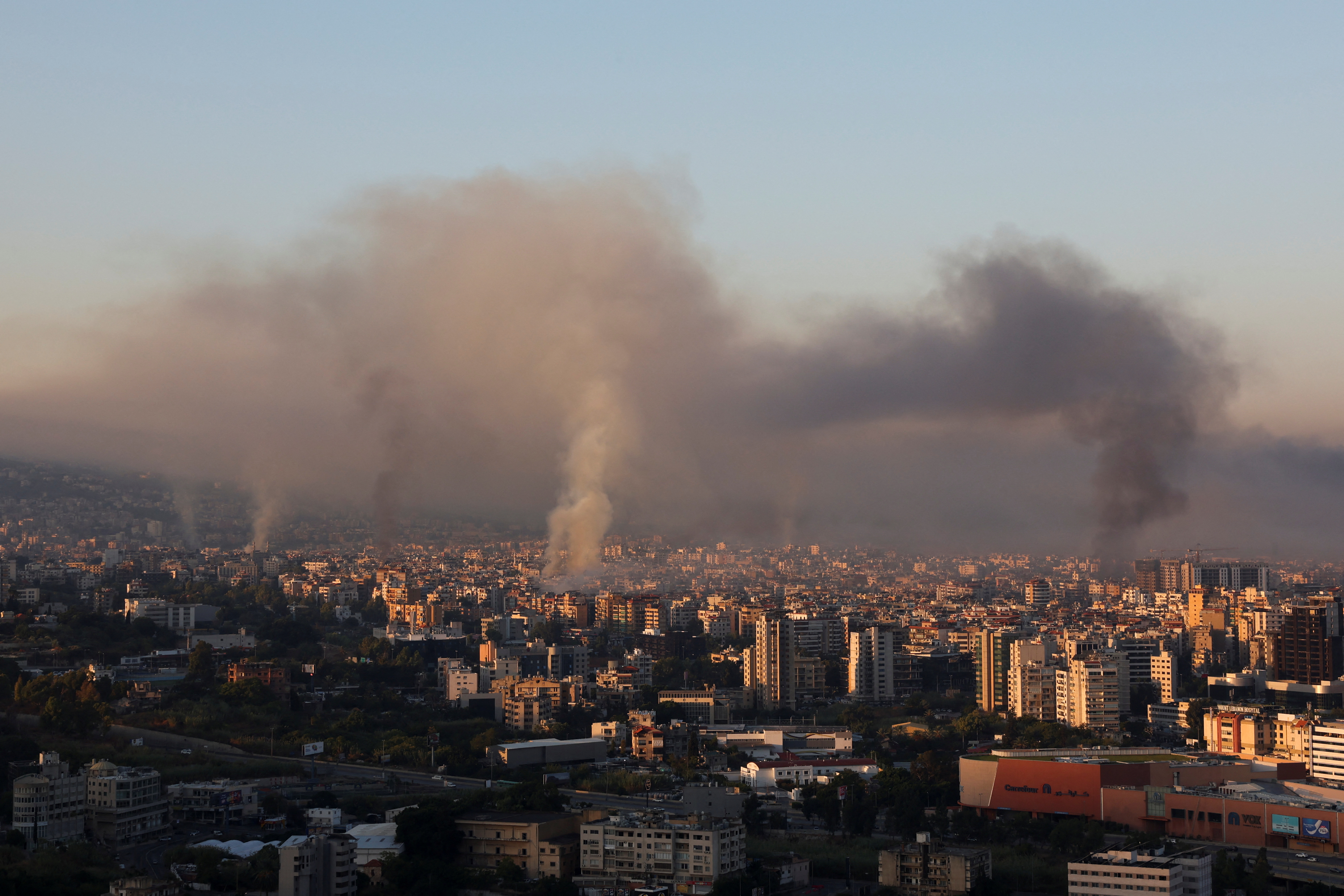 Smoke billows over Beirut's southern suburbs, as seen from Sin El Fil