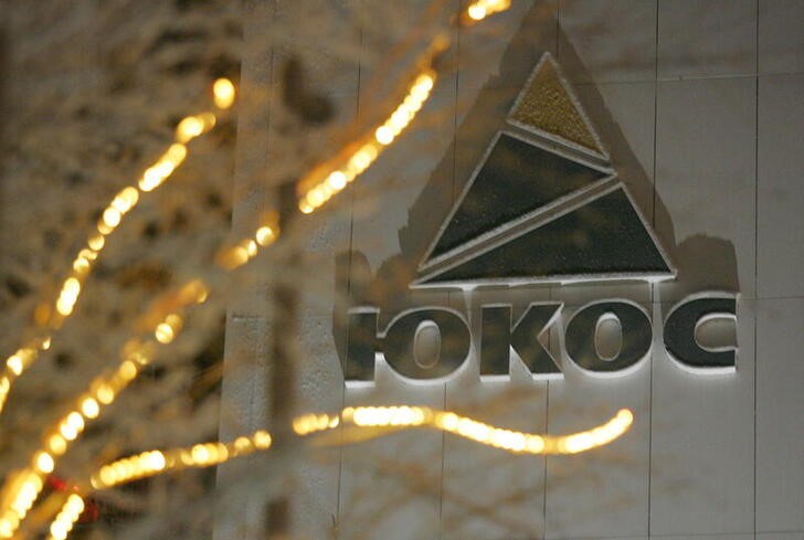 Yukos logo is seen on the wall of the headquarters building after sunset in the Russia's northern ...