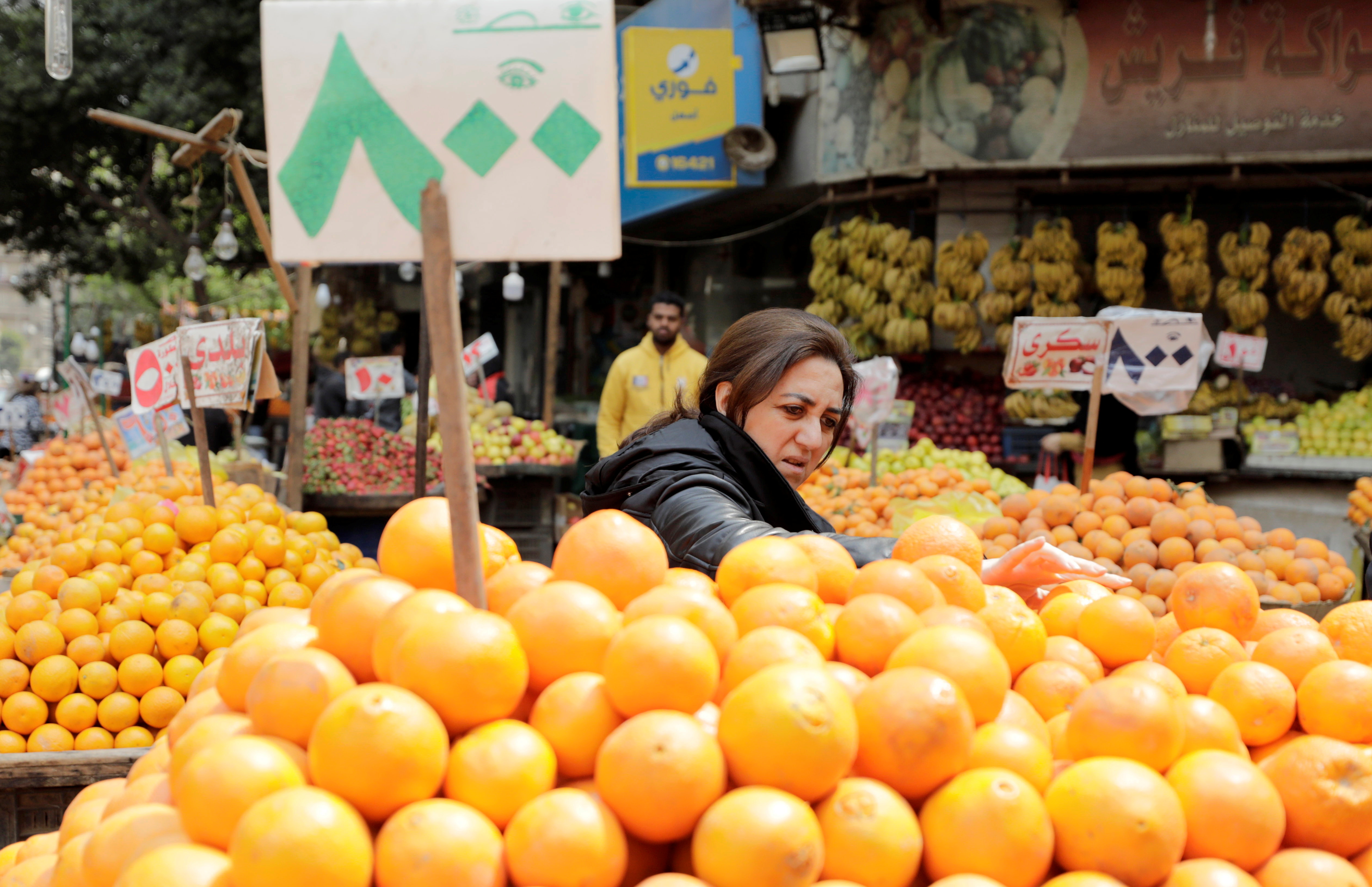 Woman shops at a vegetable and fruits market in Cairo