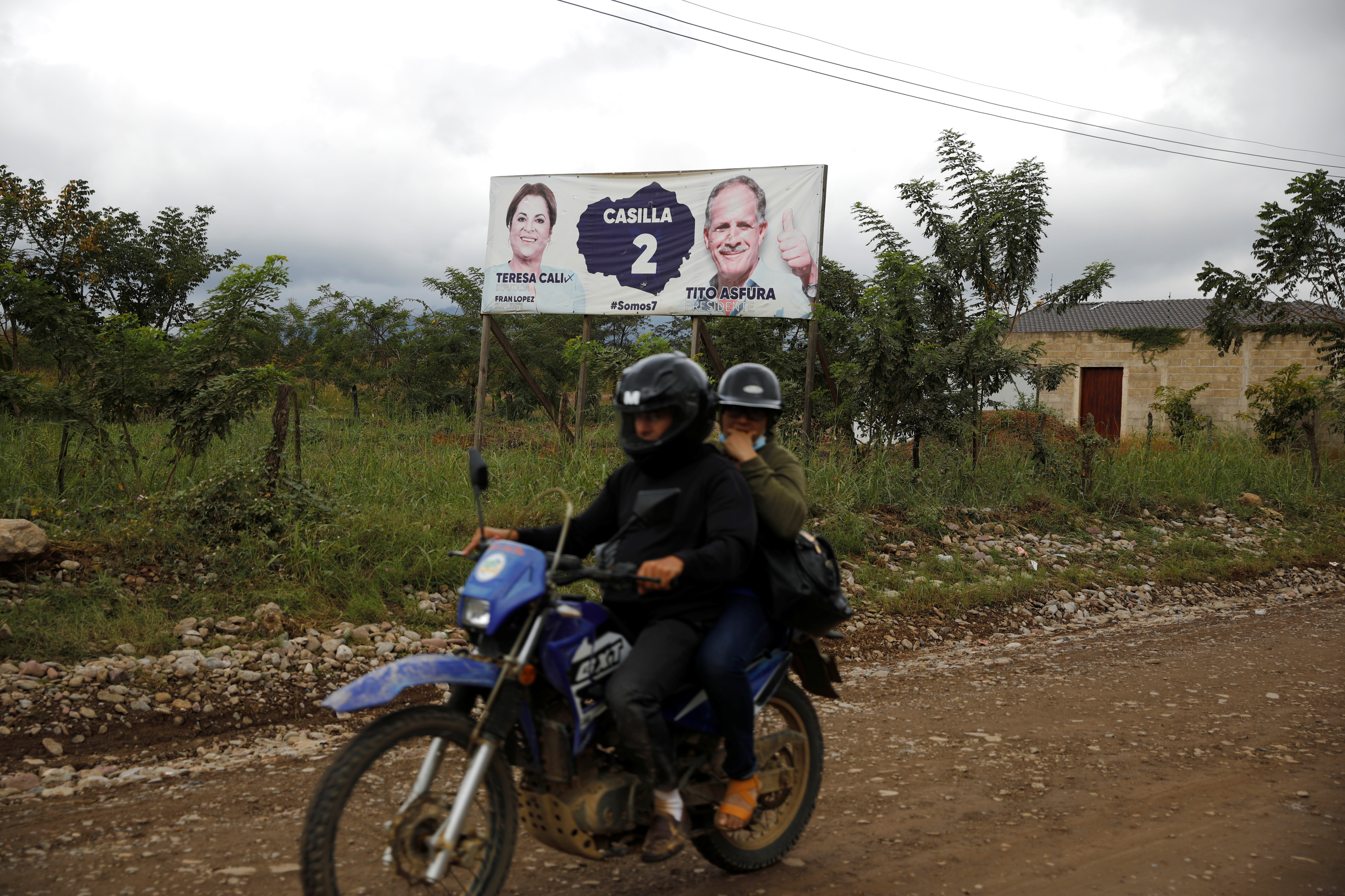 A campaign poster of Nasry Asfura, presidential candidate of the National Party of Honduras, is seen on the side of a road in Catacamas