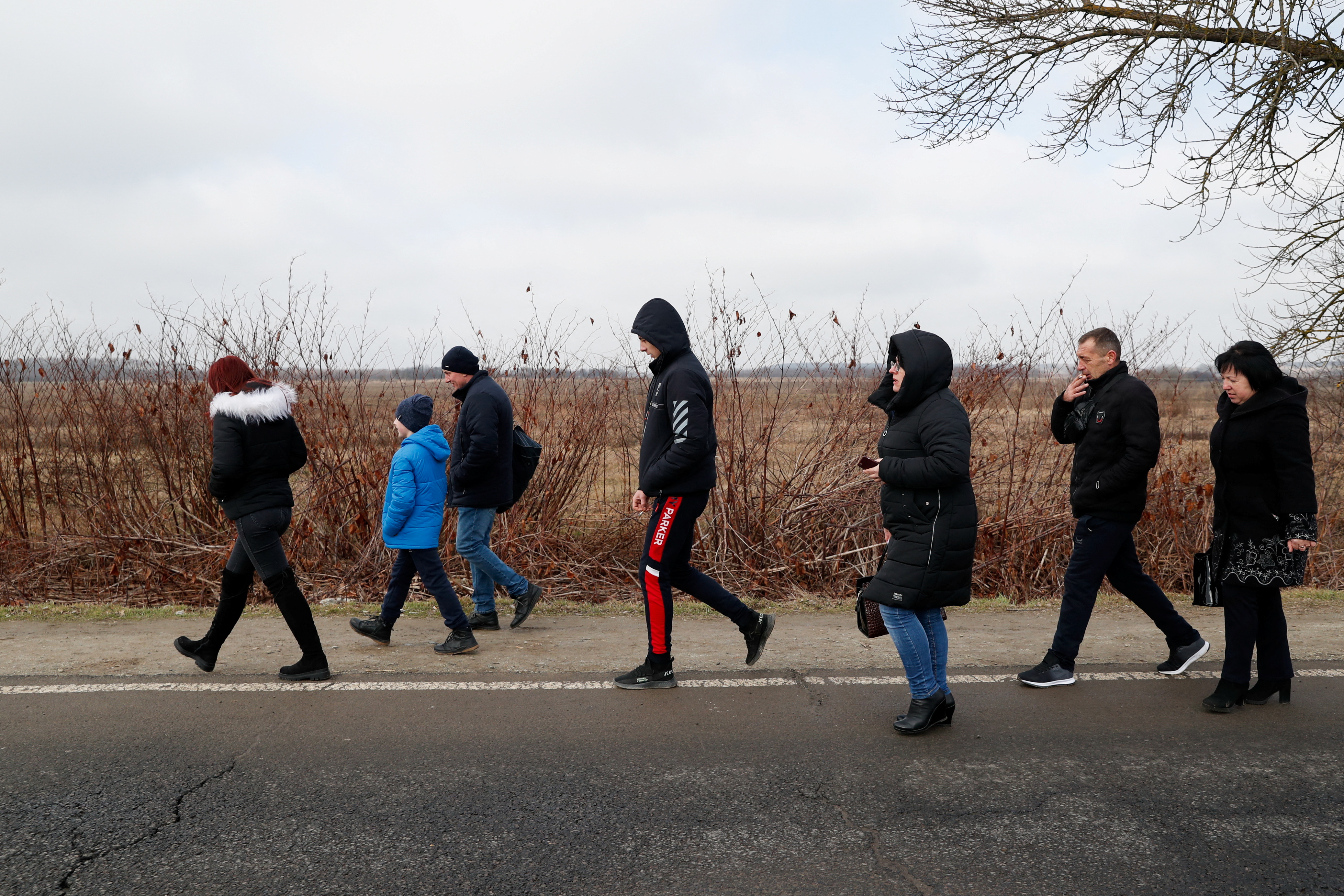 People flee from Ukraine at the Hungarian-Ukrainian border, in Beregsurany