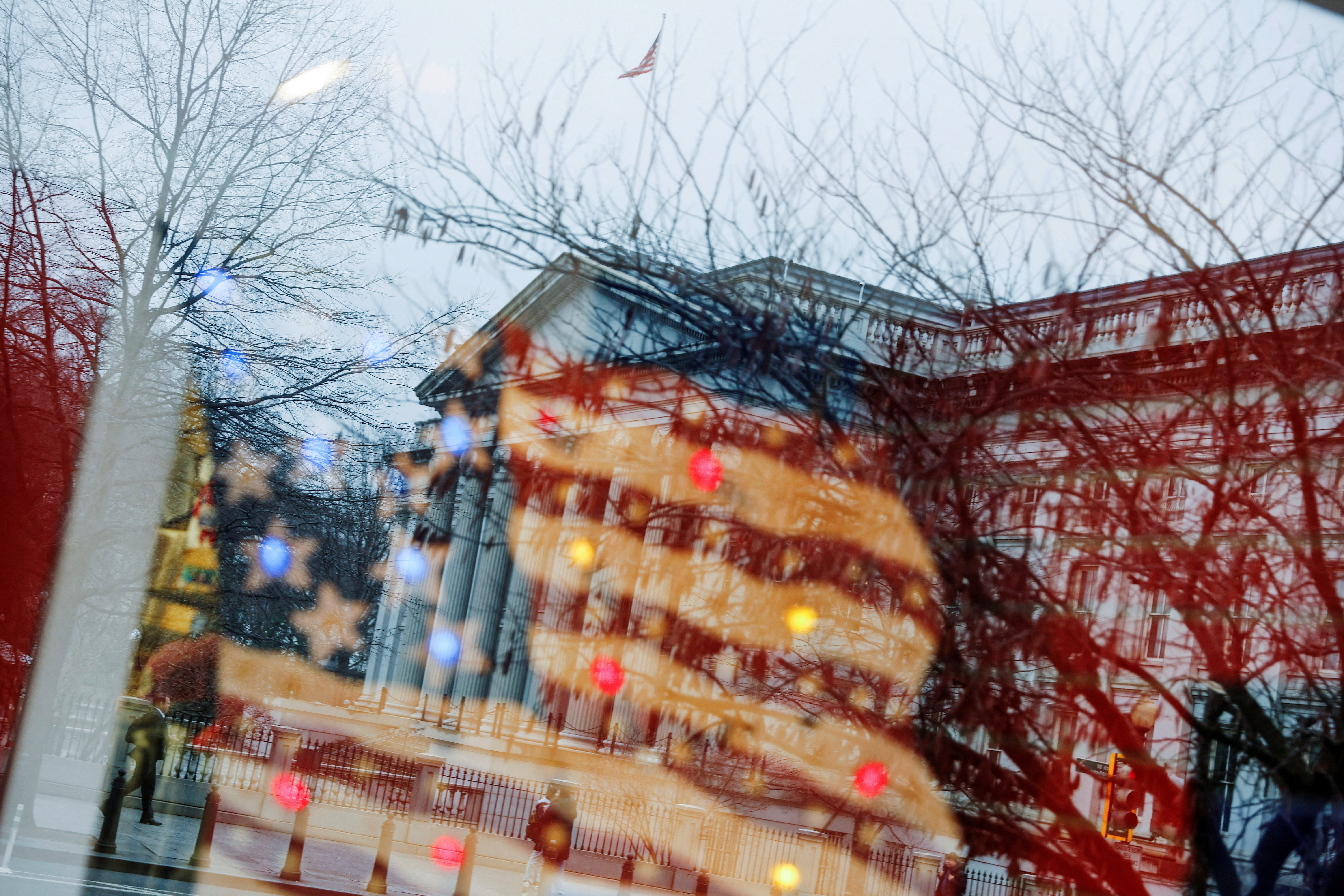 The U.S. Treasury building is seen reflected in the window of a souvenir shop in Washington