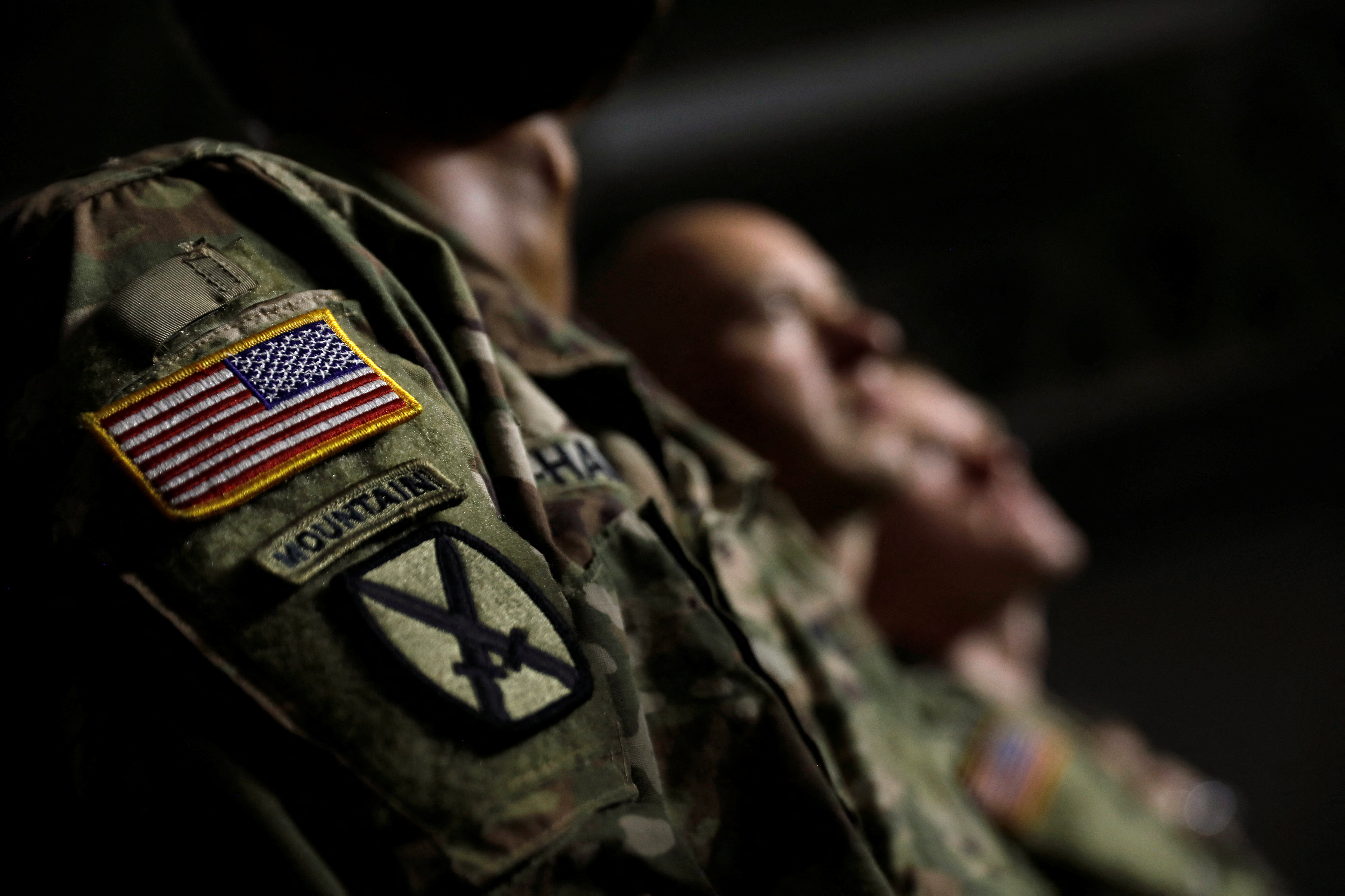 U.S. Army soldiers listen as President Trump speaks before signing the National Defense Authorization Act at Fort Drum, New York