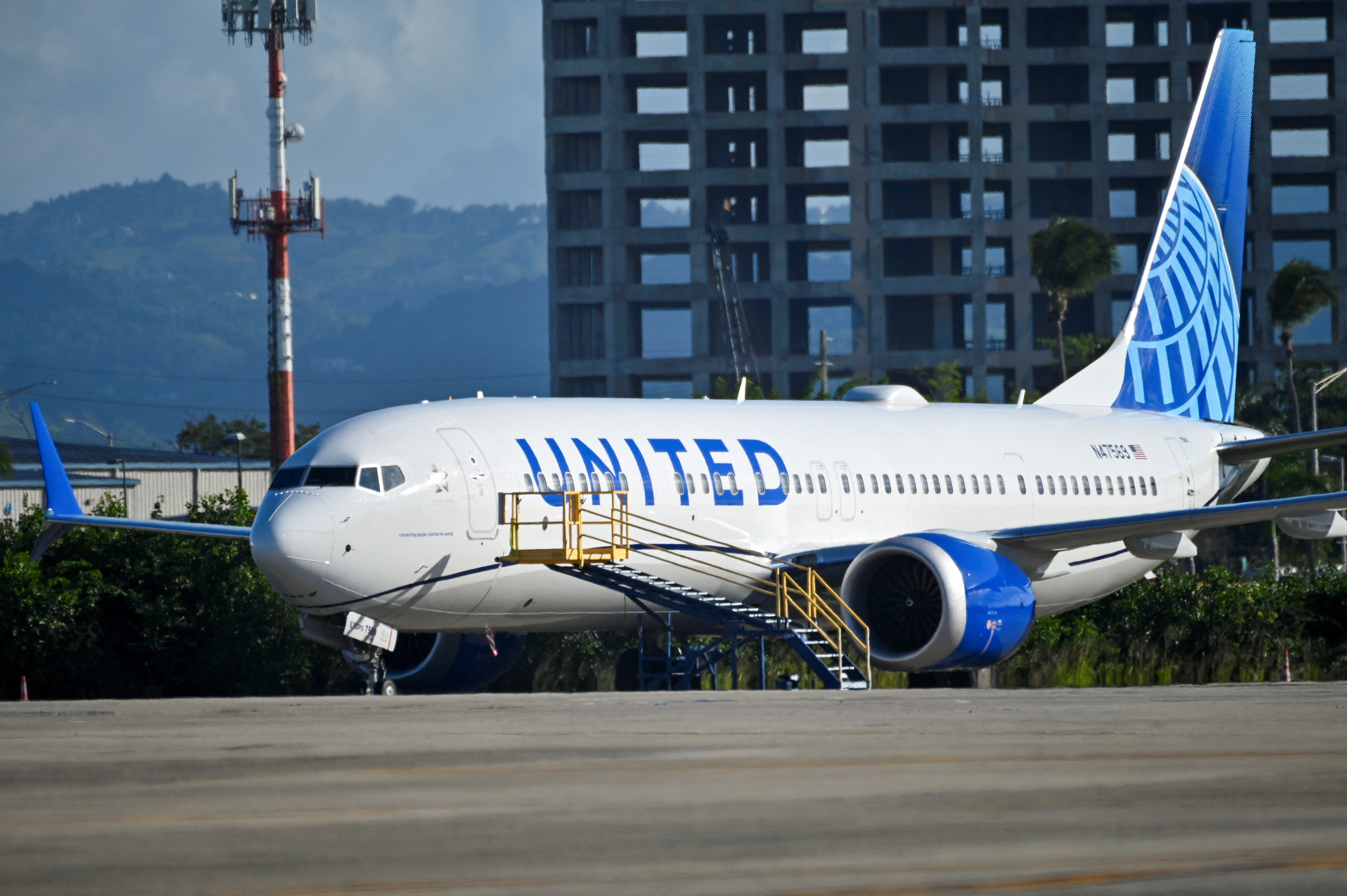 Passengers try to rebook their tickets from cancelled United Airlines flights in San Juan