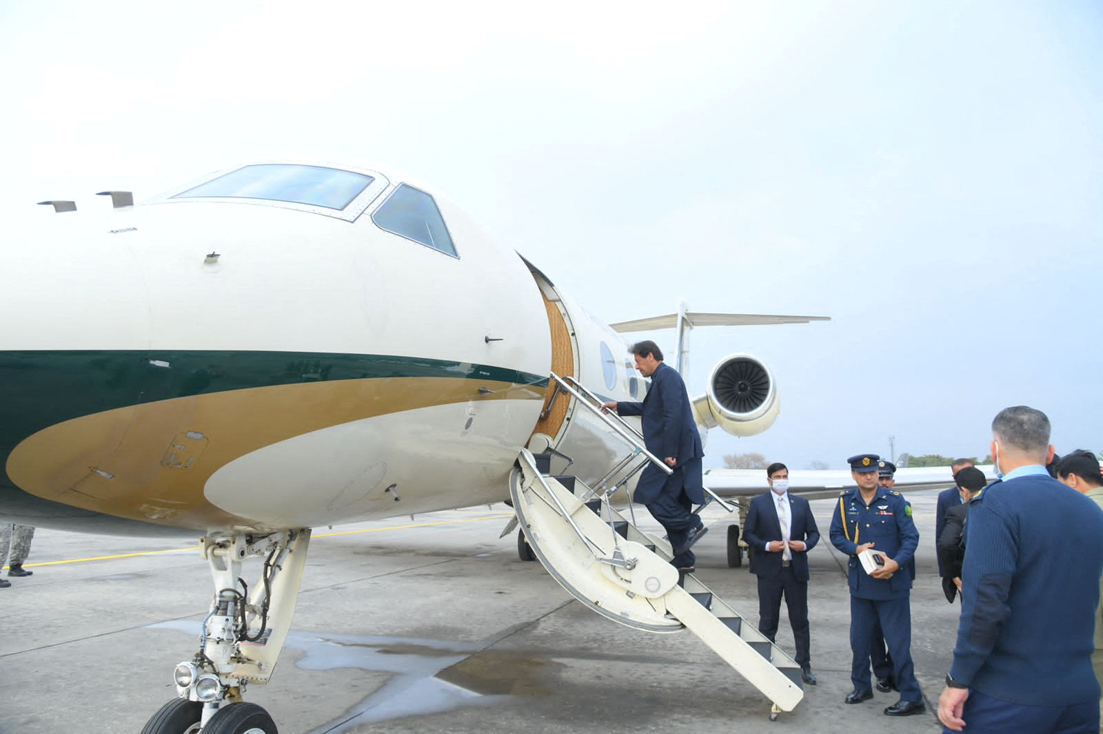 Pakistan's Prime Minister Imran Khan boards a plane before his departure to Moscow, at an airbase in Islamabad