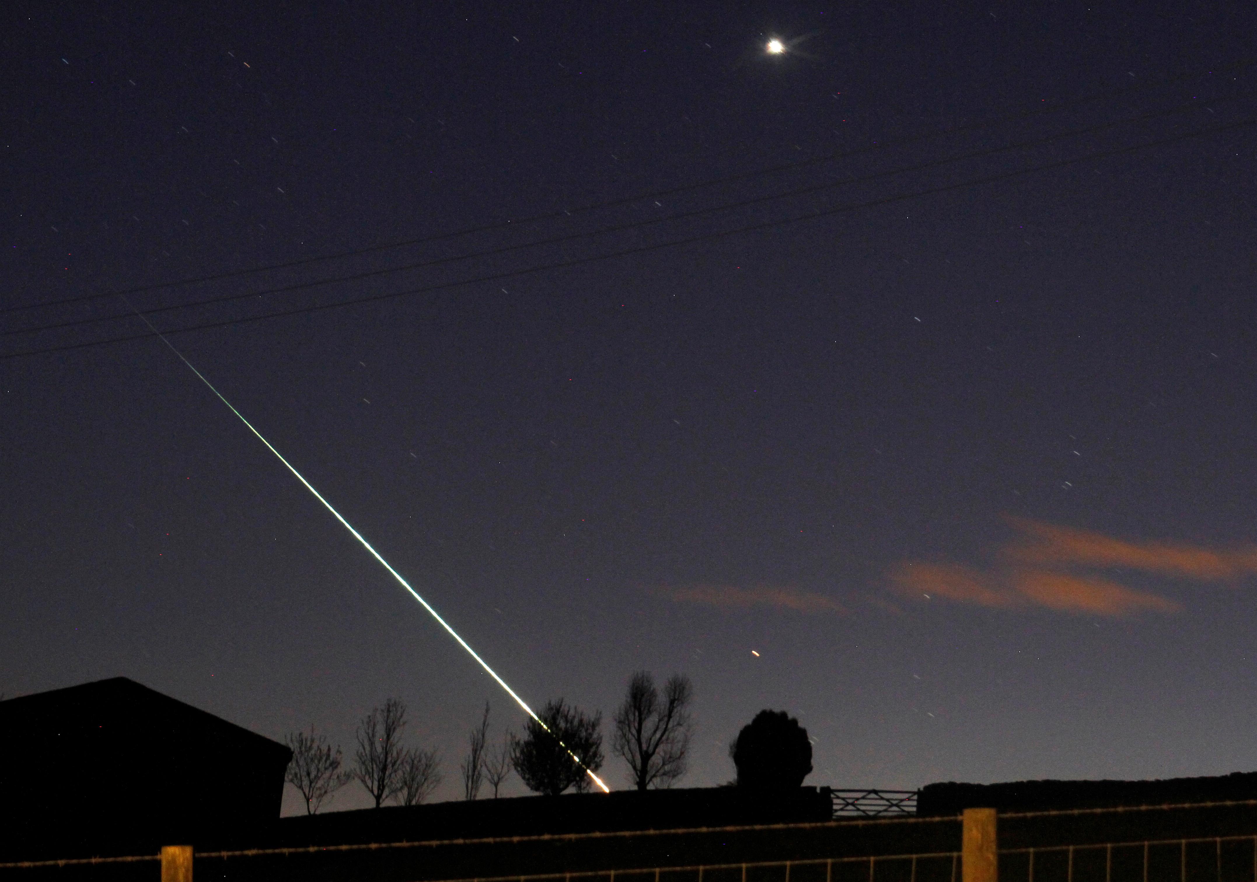 A meteorite creates a streak of light across the night sky over the North Yorkshire moors at Leaholm, near Whitby, northern England