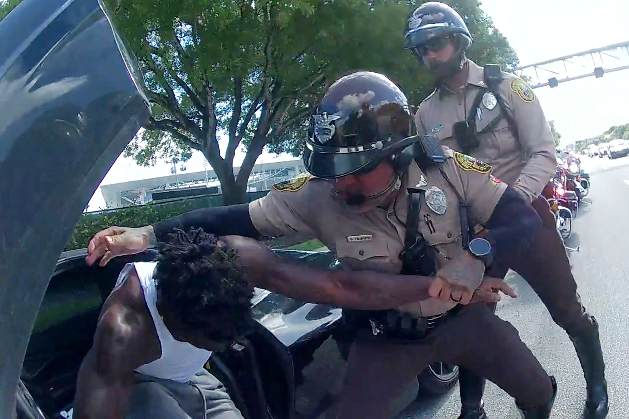 Miami Dolphins receiver Tyreek Hill is forced from his vehicle by Miami-Dade Police Department officers in Miami