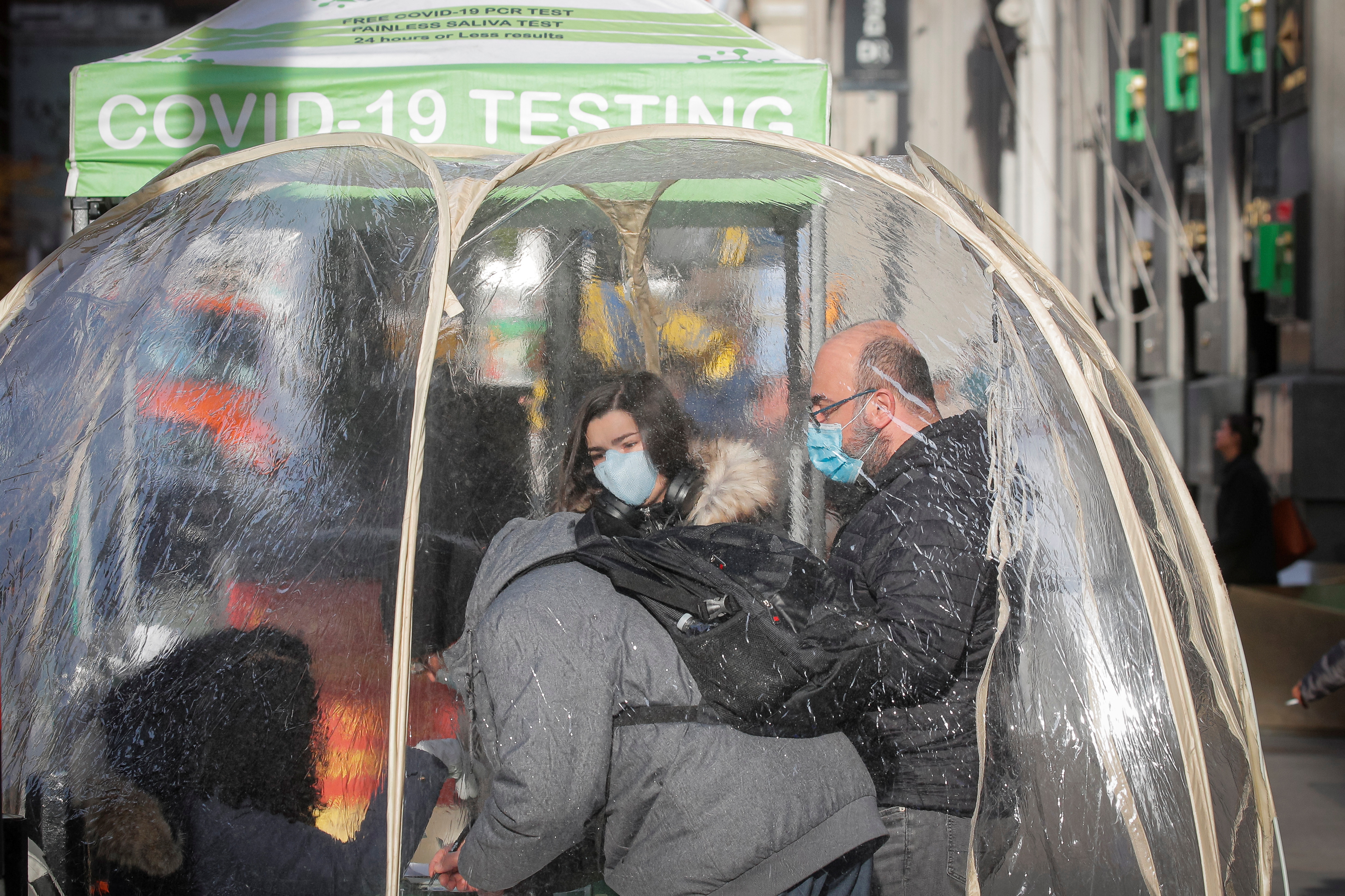 People take coronavirus disease (COVID-19) tests at a pop-up sidewalk testing site in New York