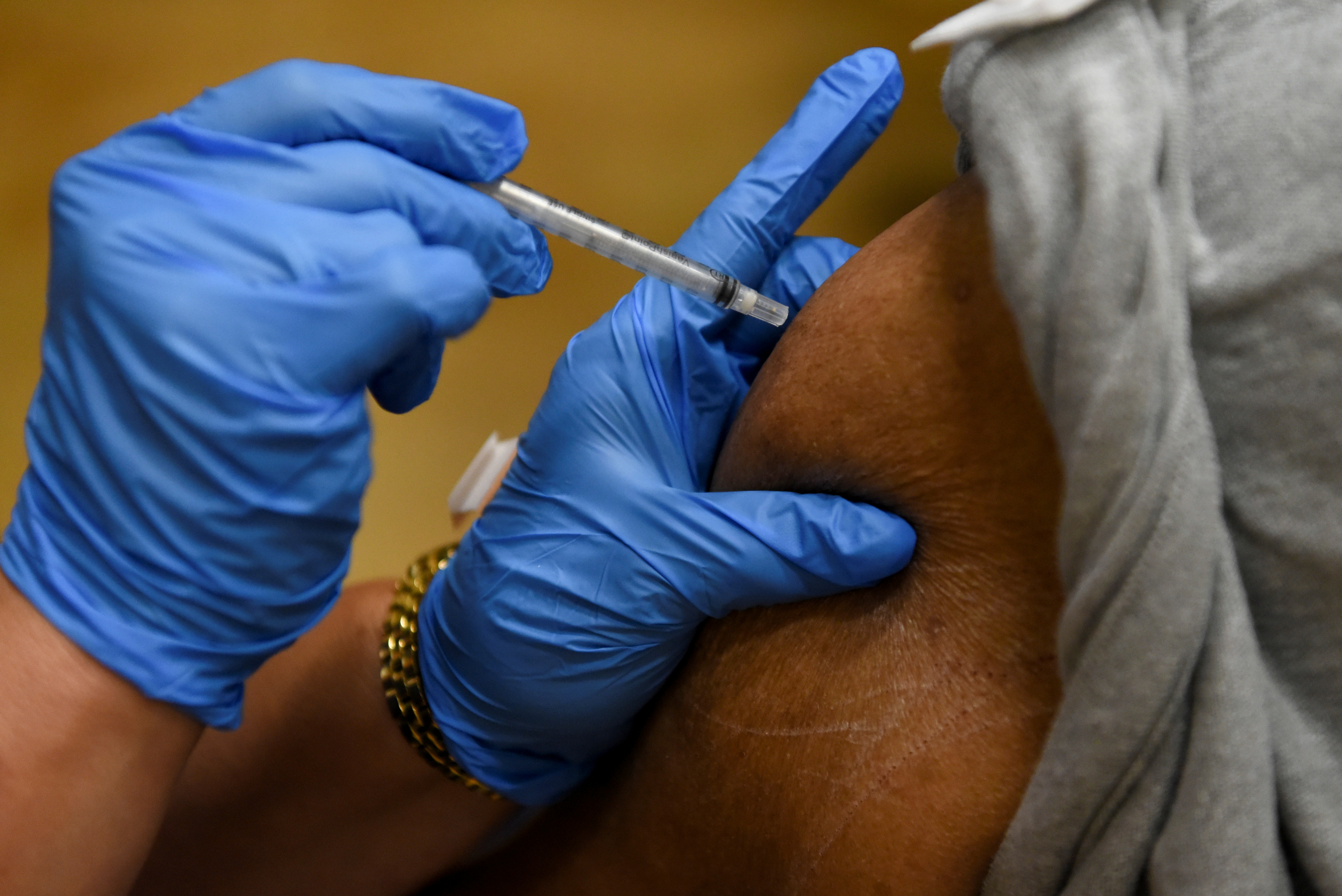 A person receives a vaccine for the coronavirus disease (COVID-19) following Republican Governor Greg Abbott's ban on COVID-19 vaccine mandates by any entity, including private employers, at Acres Home Multi-Service Center in Houston, Texas, U.S., October 13, 2021.  REUTERS/Callaghan O'Hare