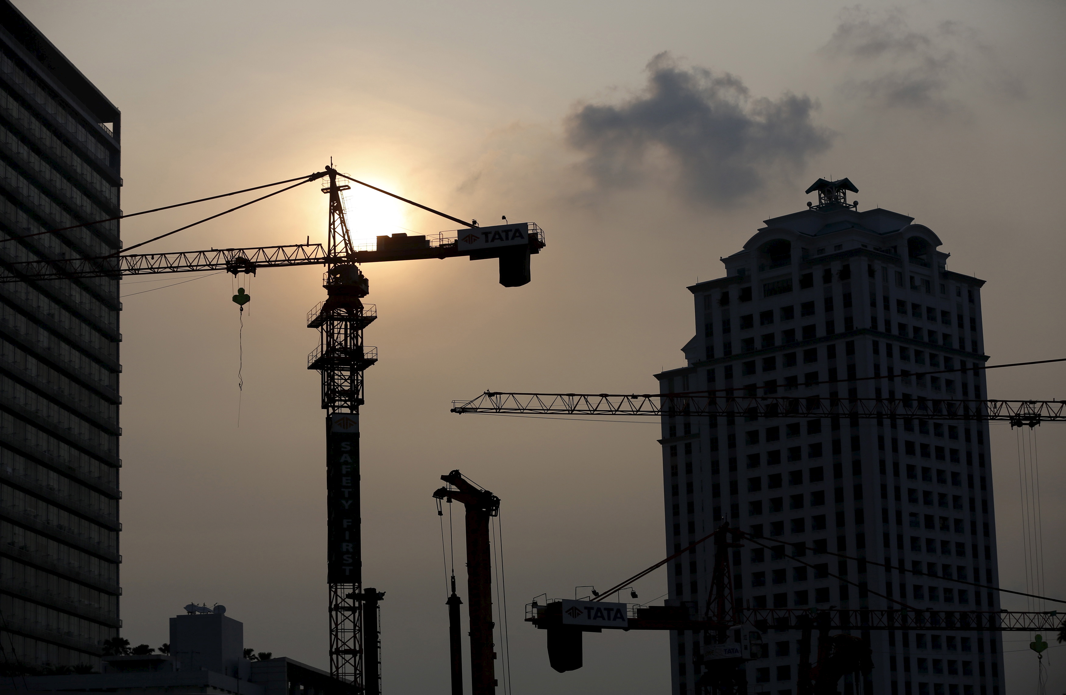 Cranes are seen over the skyline of the Indonesian capital Jakarta