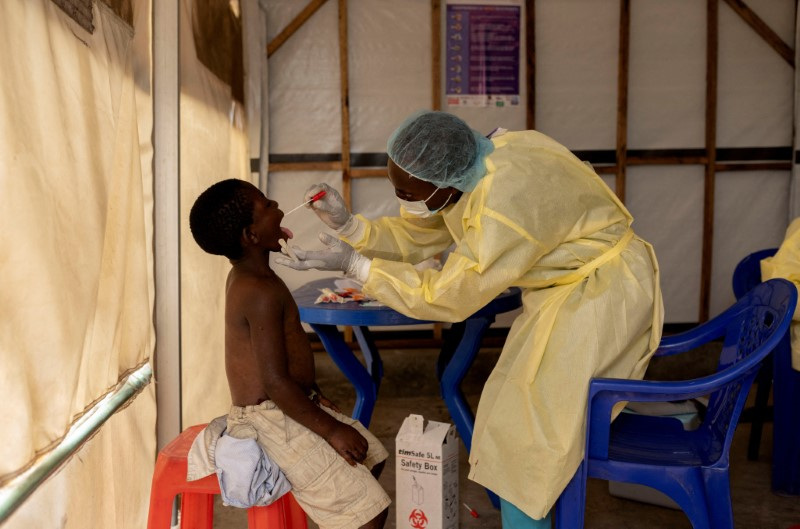 A laboratory nurse takes a sample from a child declared a suspected case Mpox at a treatment centre in Munigi, North Kivu province, Democratic Republic of the Congo