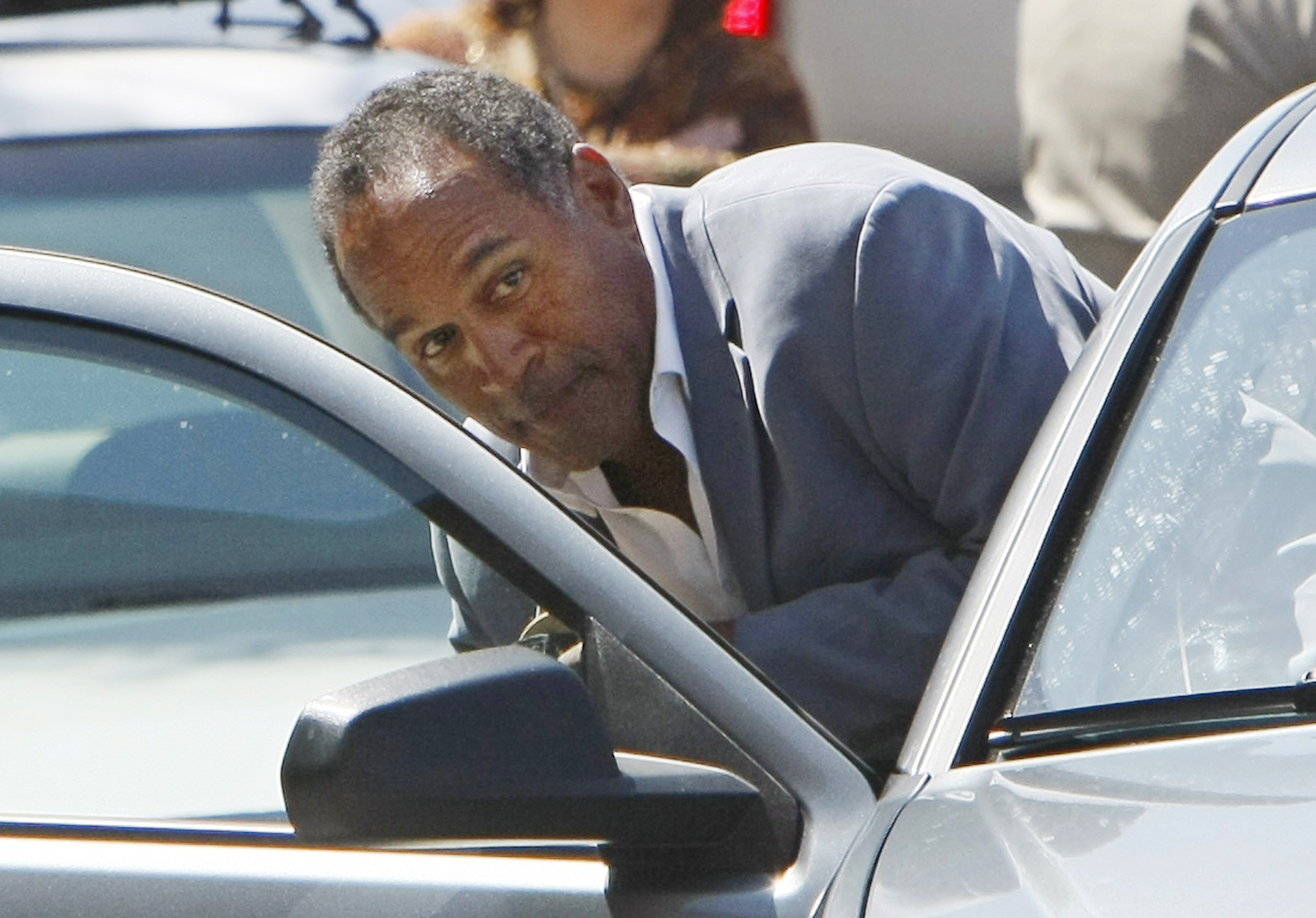 Former NFL football star O.J. Simpson ducks into his car outside the Clark County Detention Center in Las Vegas