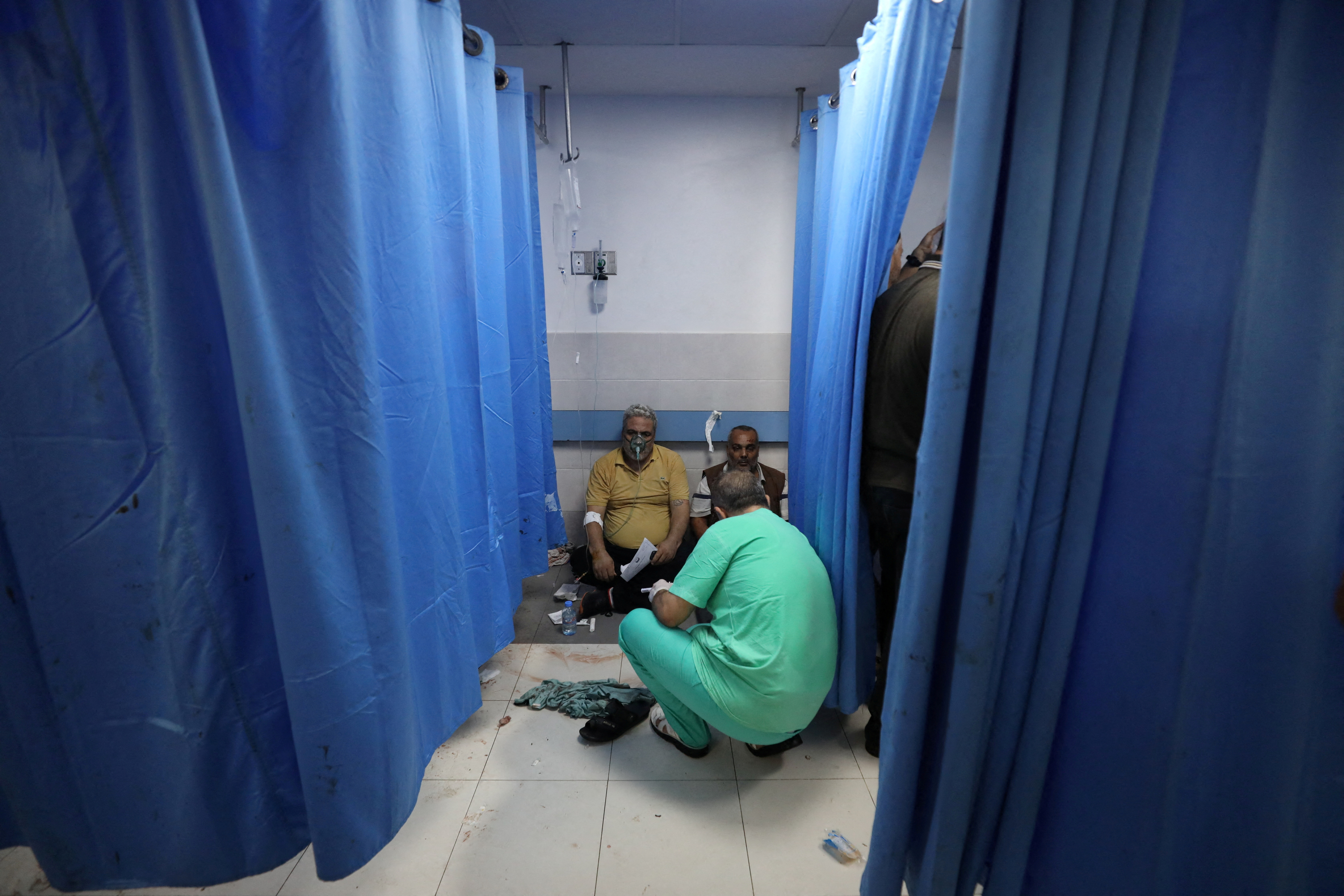 People are assisted at Shifa Hospital after hundreds of Palestinians were killed in a blast at Al-Ahli hospital in Gaza that Israeli and Palestinian officials blamed on each other