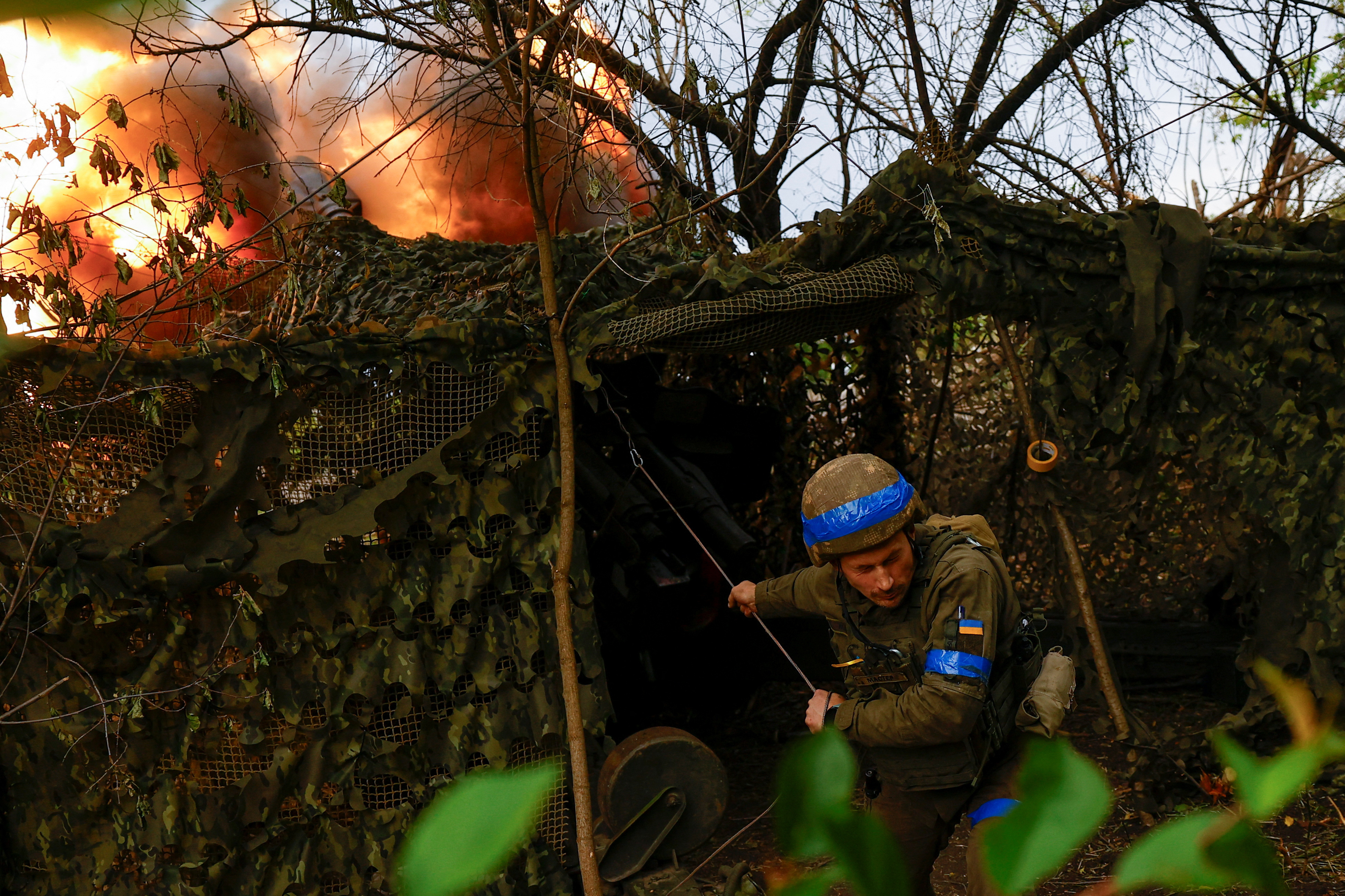 Ukrainian National Guard 'Khartiia' brigade service member and a D-20 howitzer crew commander Ivan Liashko fires towards Russian troops in a front line in Kharkiv region