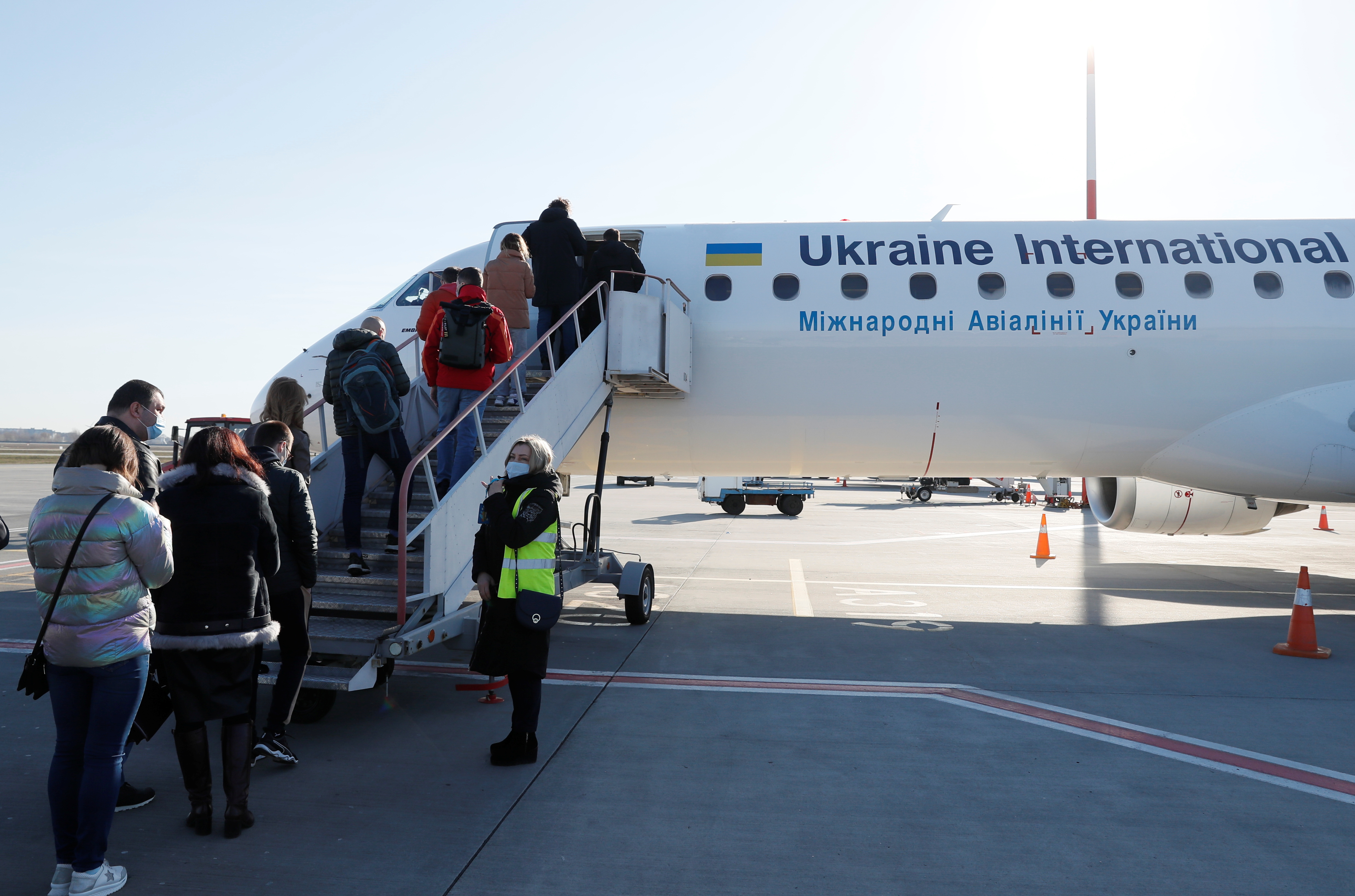 Passengers board a Ukraine International Airlines plane