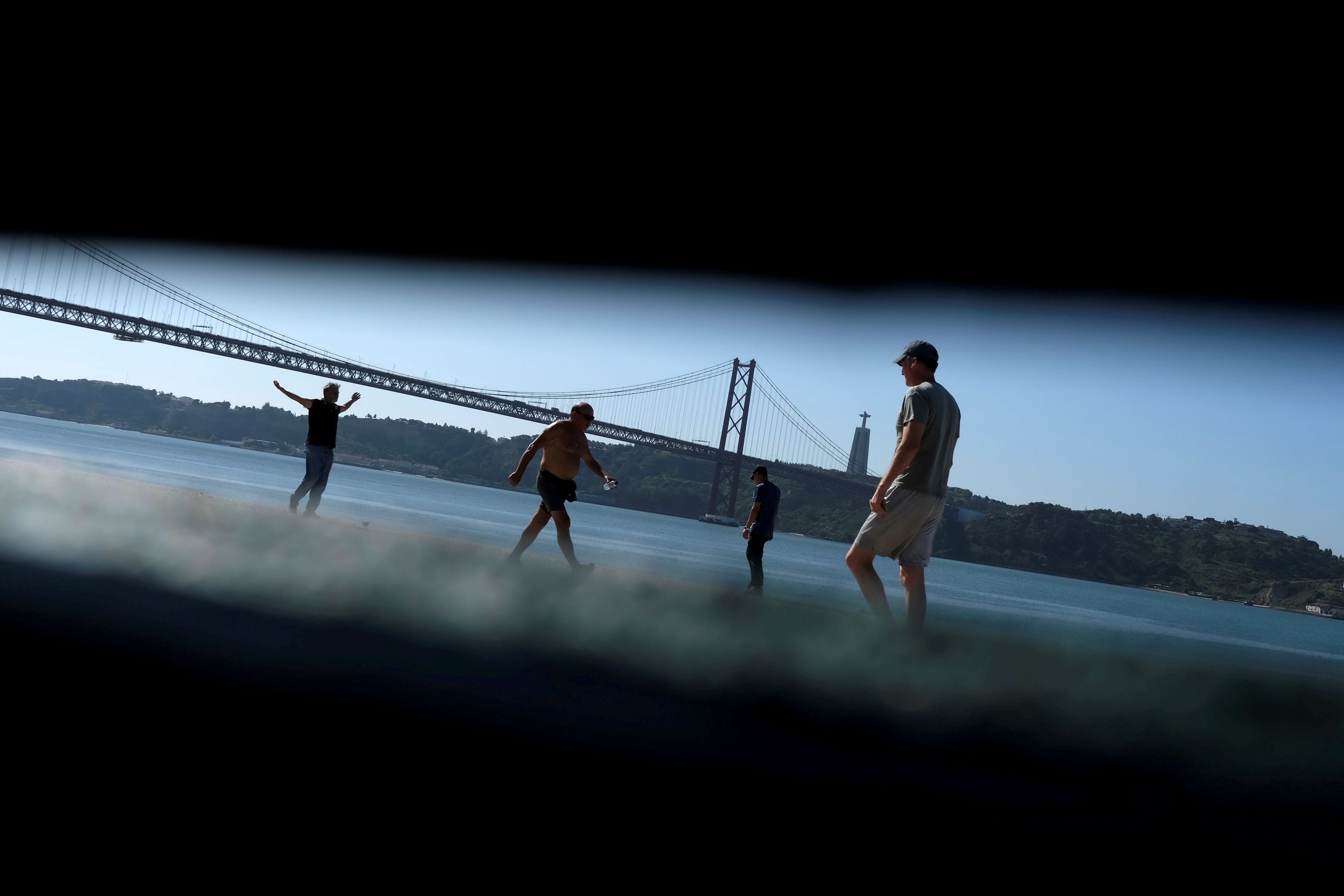 People walk near Tagus river amid COVID-19 pandemic, in Lisbon