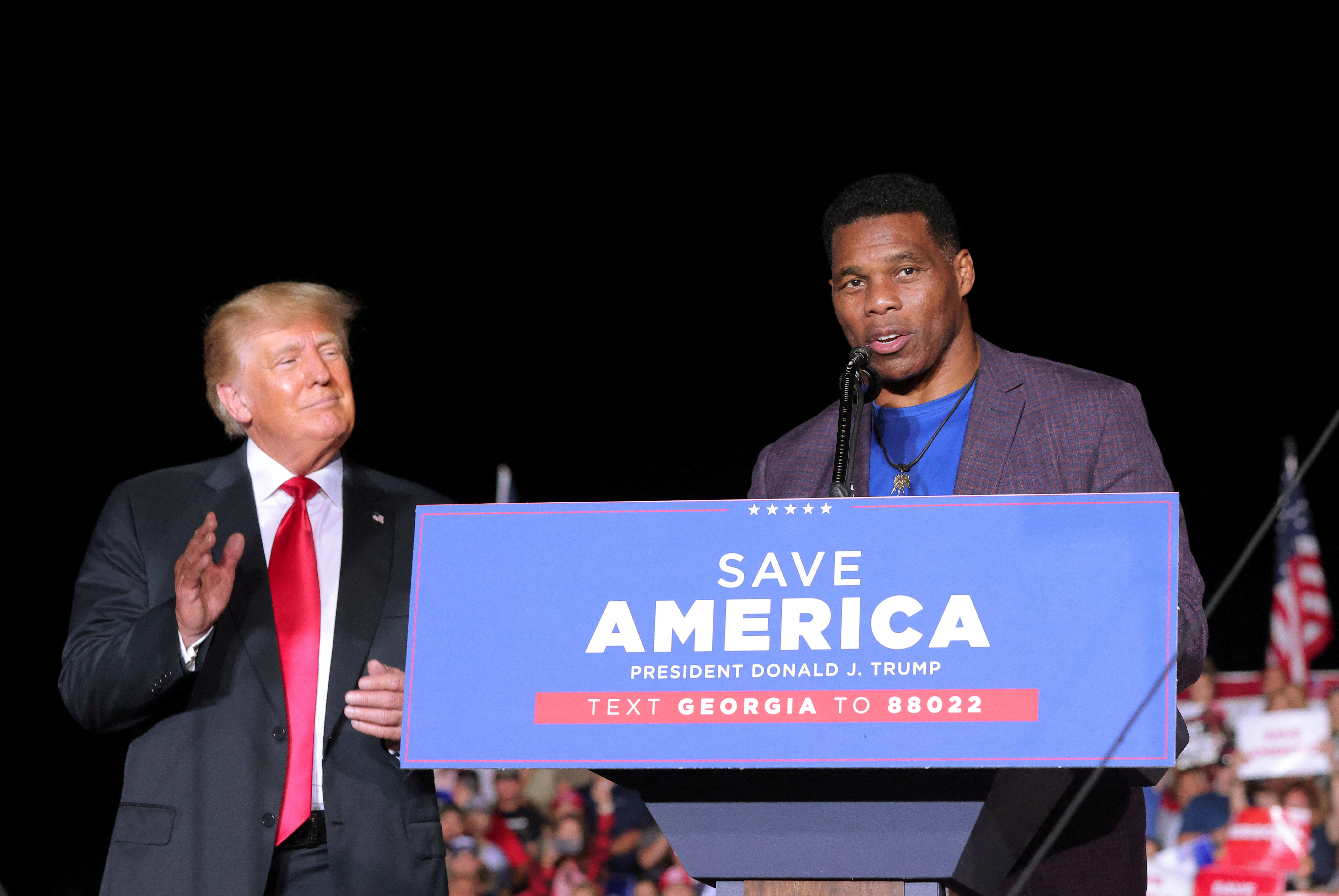 Former college football star and current senatorial candidate Herschel Walker speaks at a rally in Perry