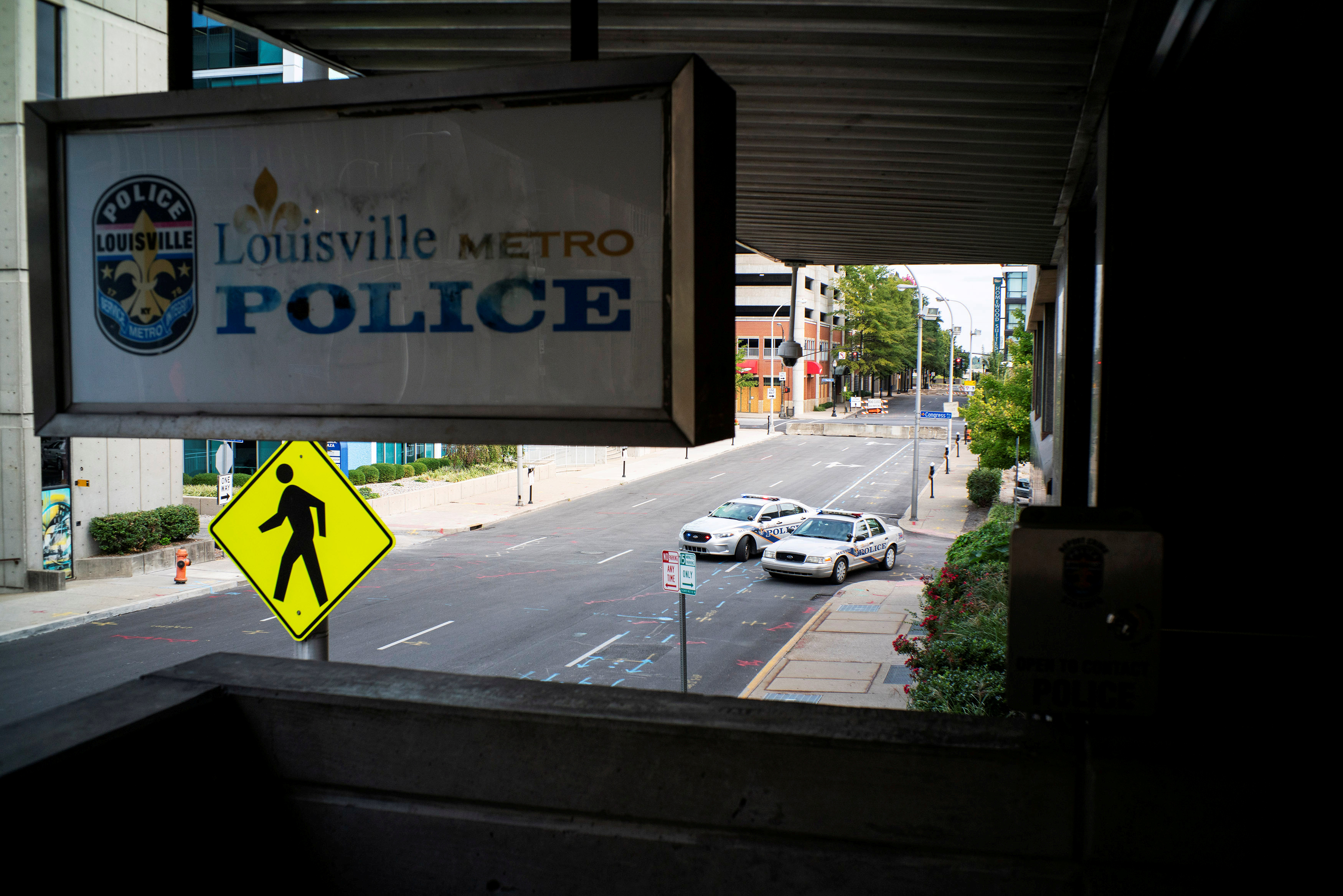 Louisville police cars stand guard outside the police station in an empty street after a grand jury decided not to bring homicide charges against police officers involved in the fatal shooting of Breonna Taylor, in Louisville, Kentucky September 26, 2020. REUTERS/Eduardo Munoz - RC2F6J9DZBN7