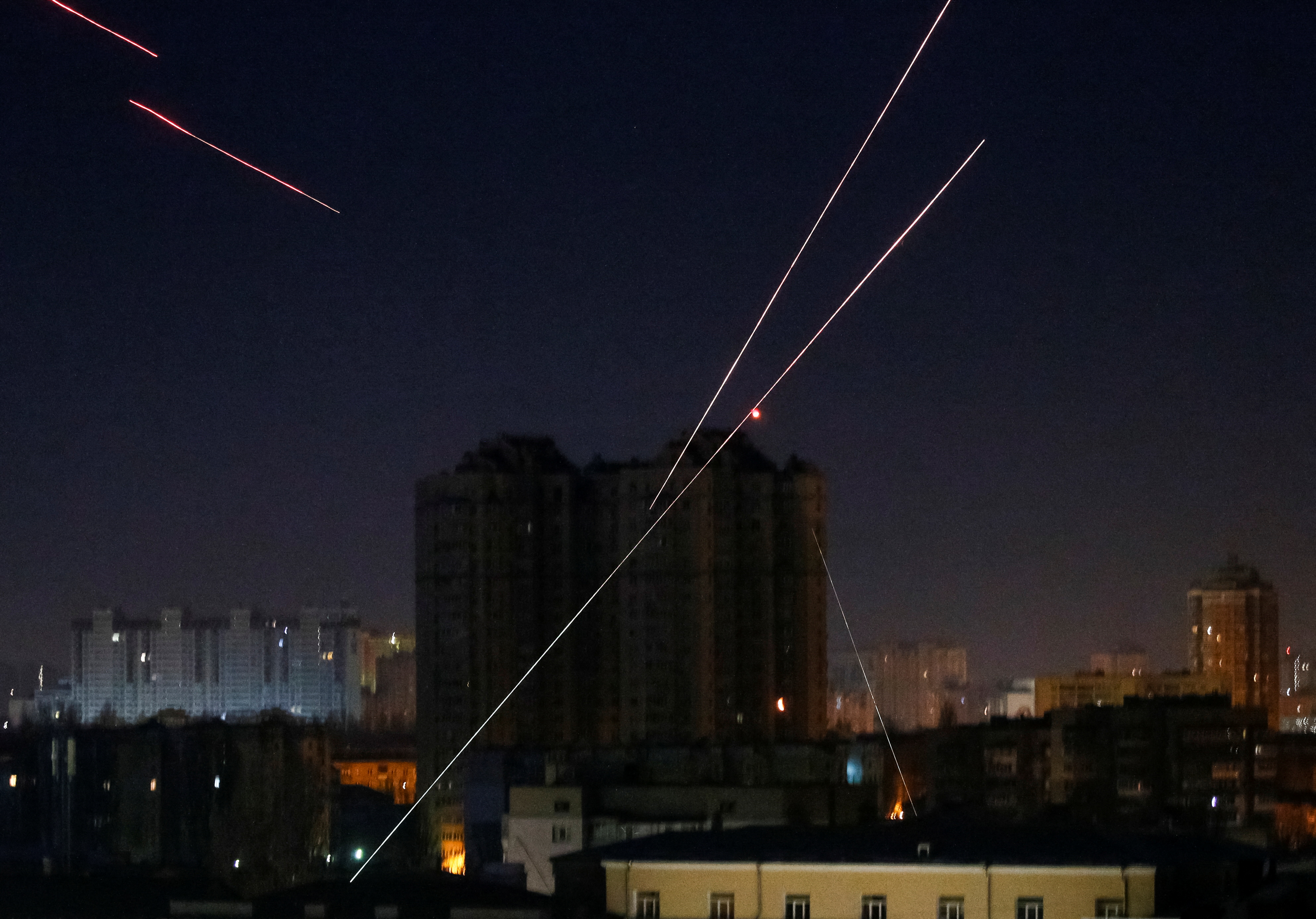 Tracers are seen in the night sky as Ukrainian servicemen fire on the drone in Kyiv