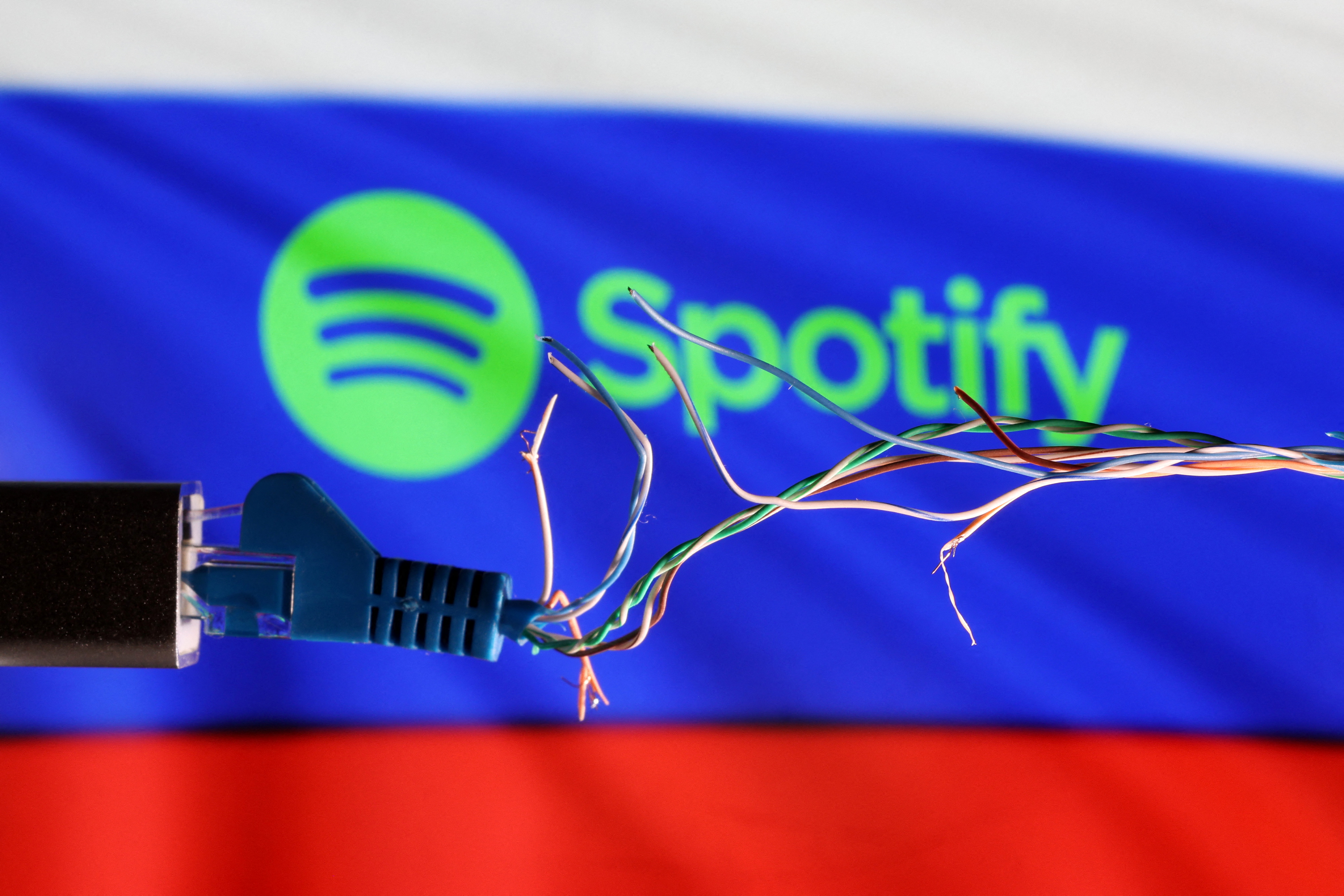 Illustration shows Broken Ethernet cable, Russian flag and Spotify logo