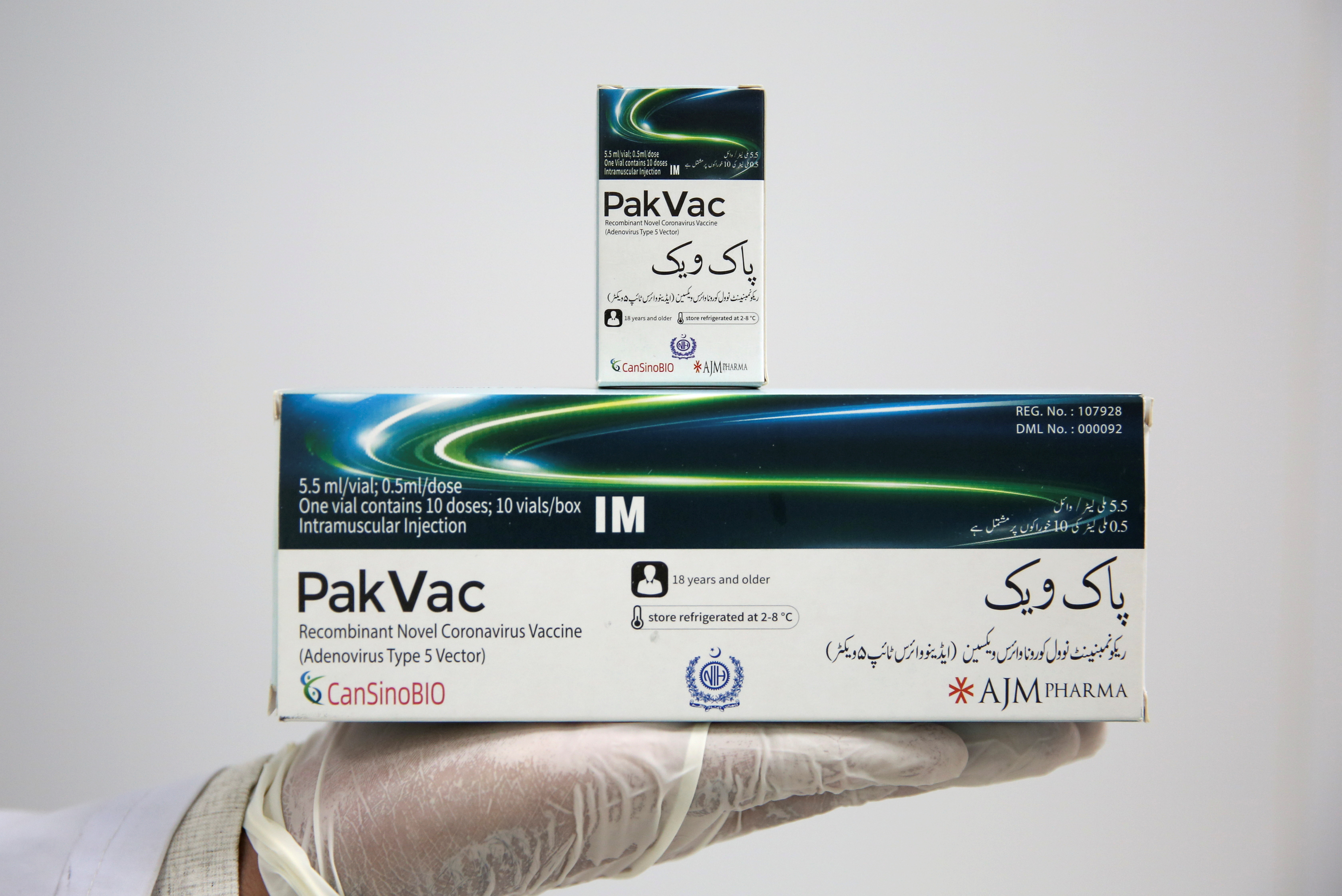 A lab technician displays packs of PakVac coronavirus disease (COVID-19) vaccine, which is being produced locally, at the National Institute of Health (NIH) in Islamabad