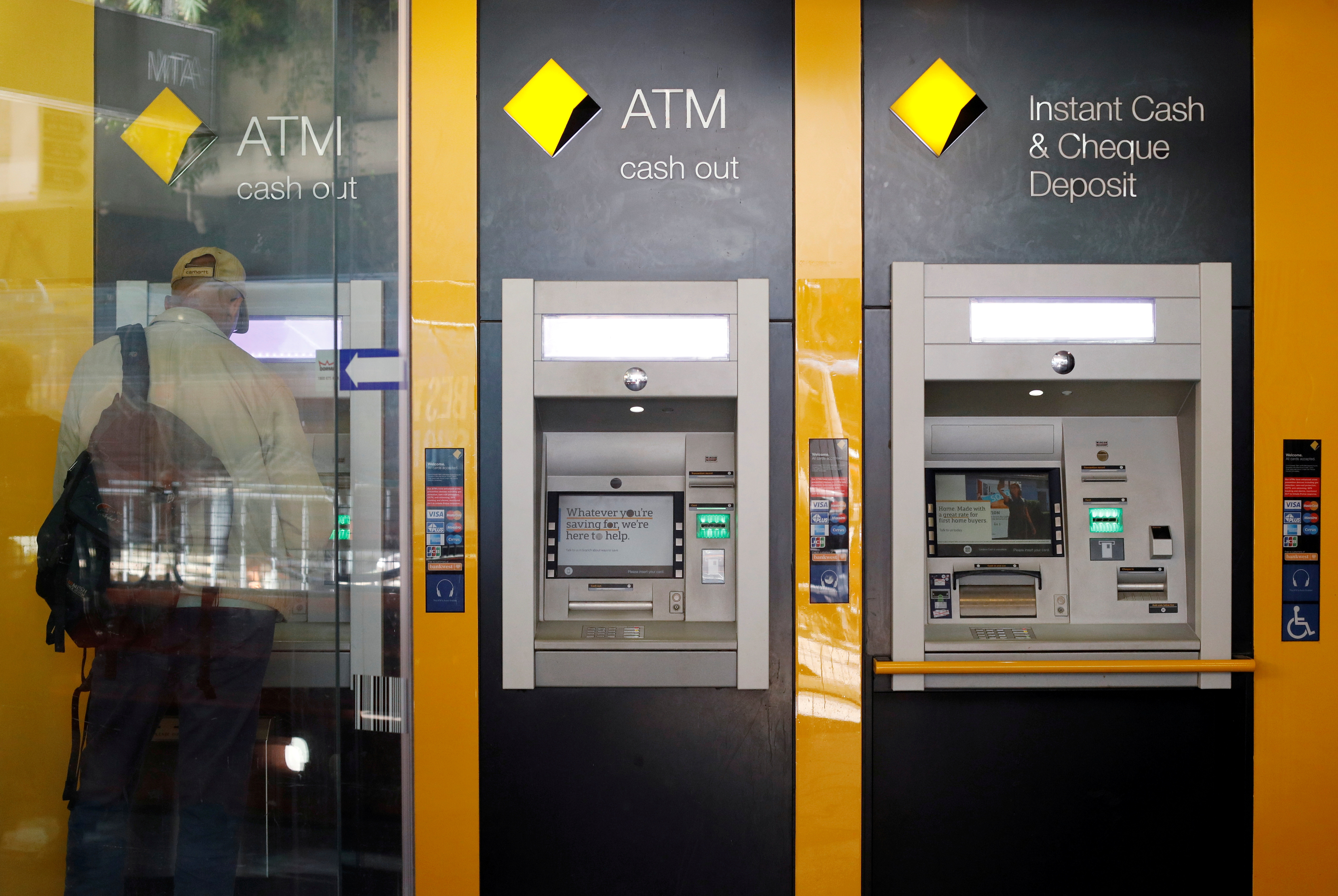 A man uses a Commonwealth Bank of Australia ATM in Sydney