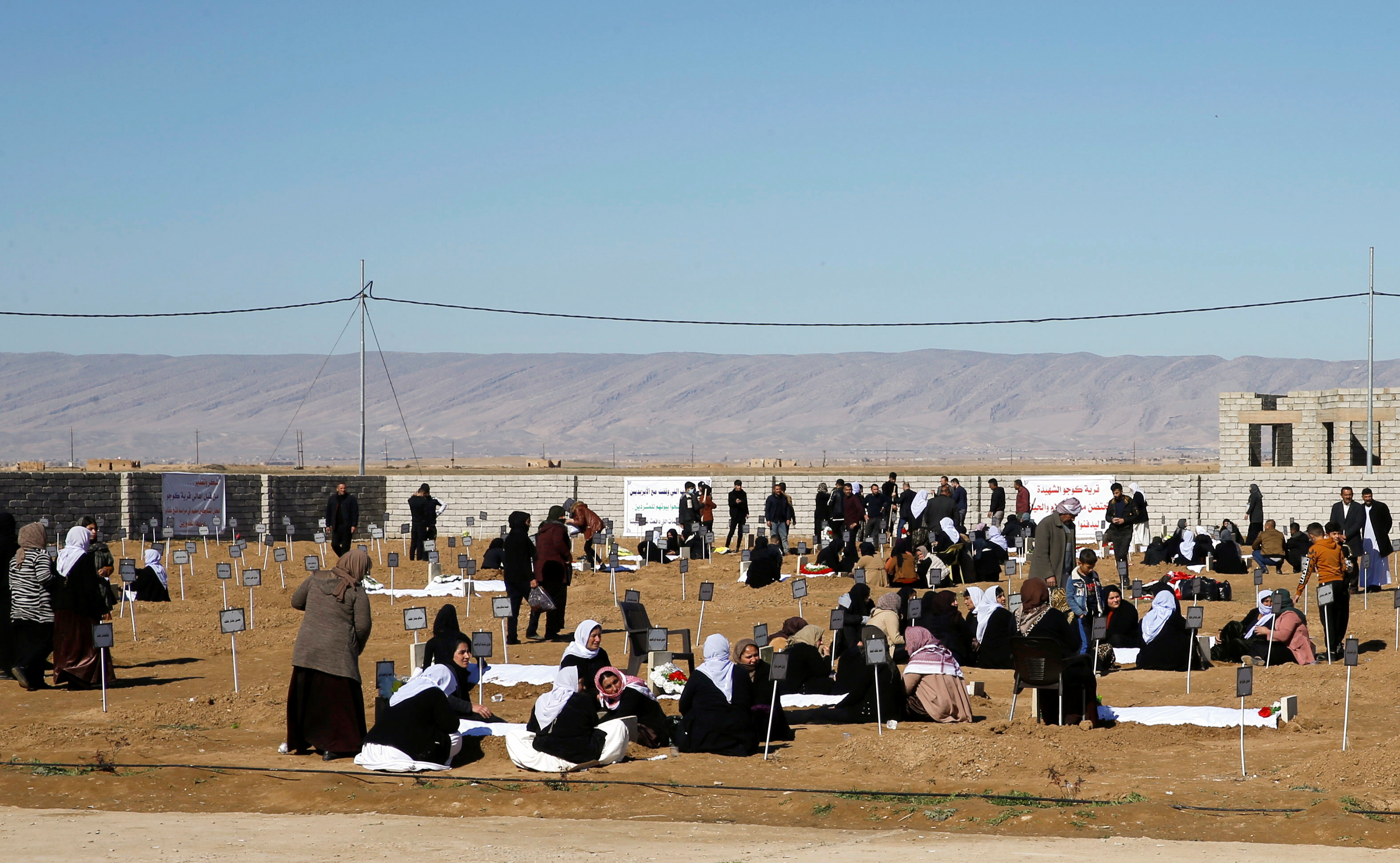 Yazidi minority residents visit a cemetery for victims killed in past Islamic State militant attacks, in Kojo
