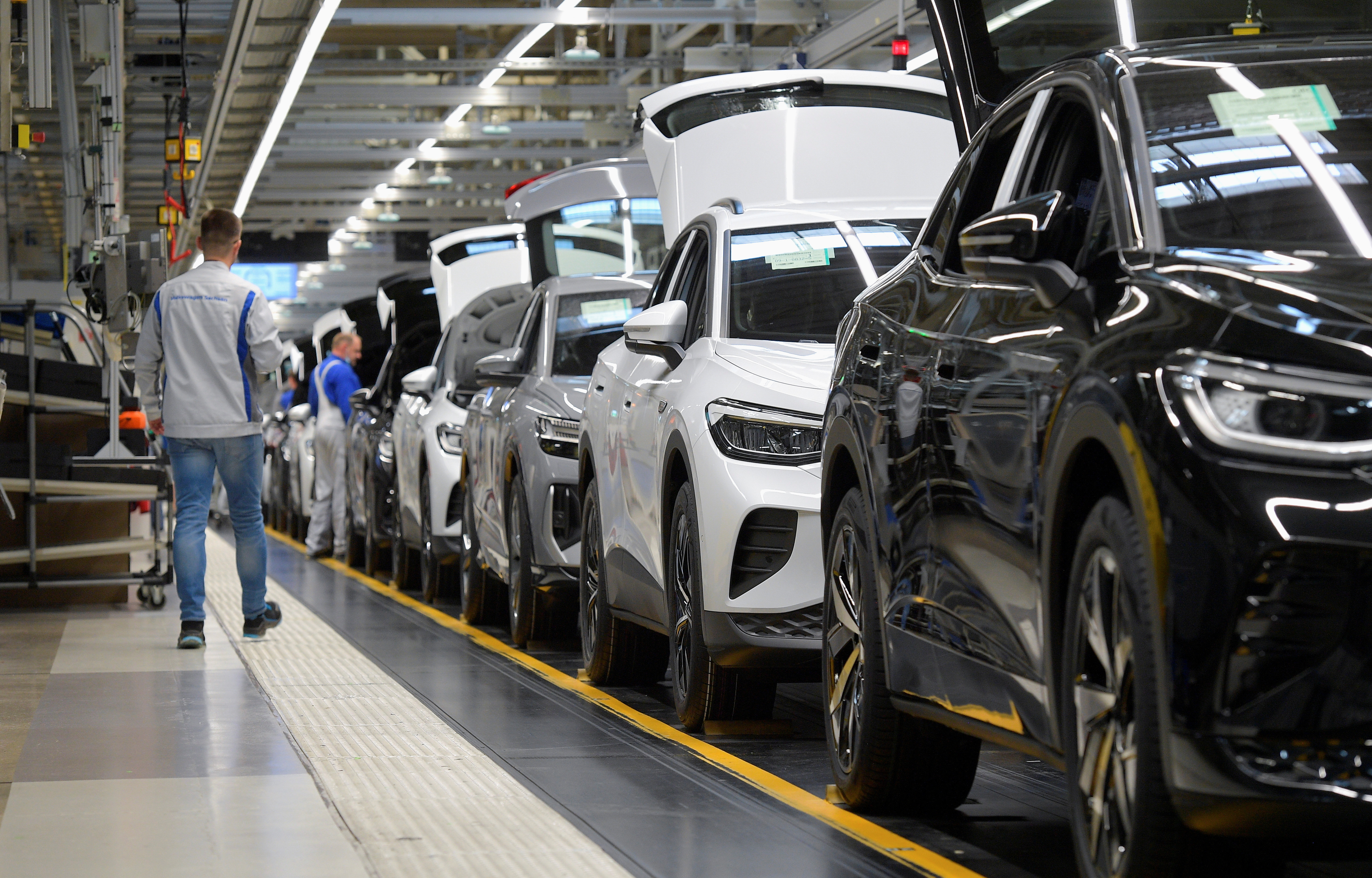 Technicians work at the production line for electric car models of the Volkswagen Group in Zwickau