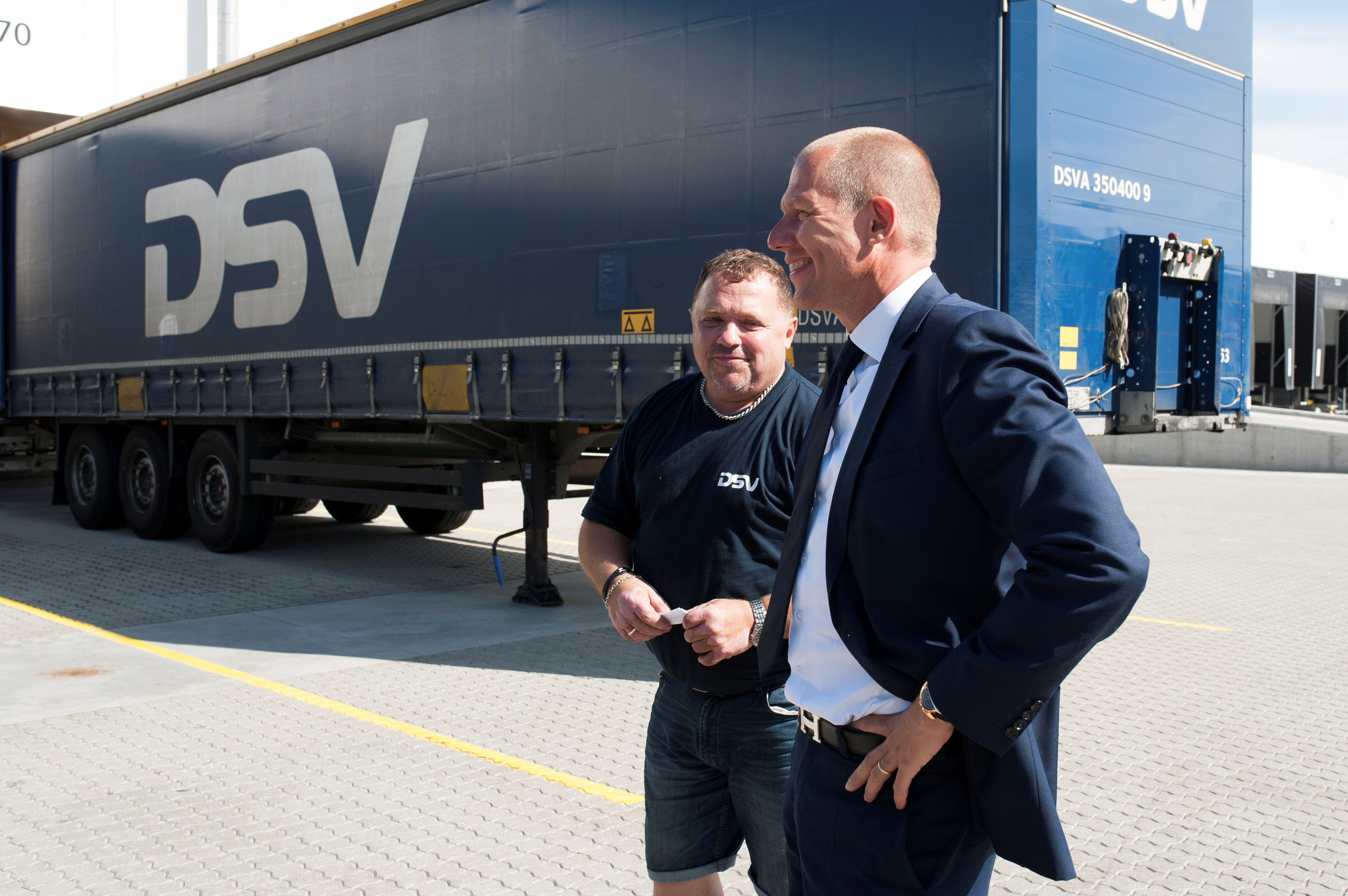 Denmark’s DSV CEO Andersen talks to a truck driver at the company’s headquarter outside Copenhagen
