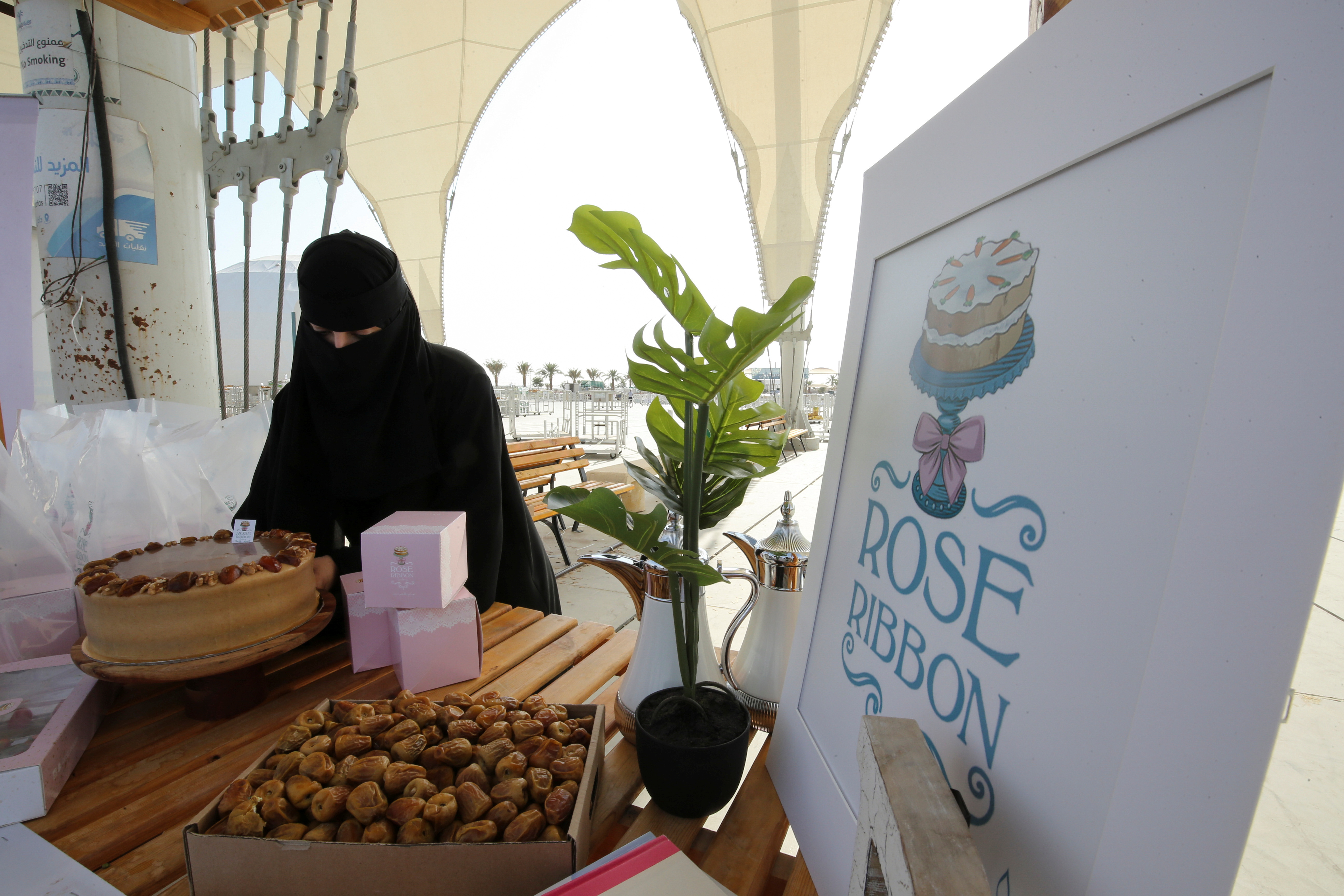 Ghada Al-Salman, 33, sets up her Rose Ribbon Bakery stall at Unaizah Season for Dates